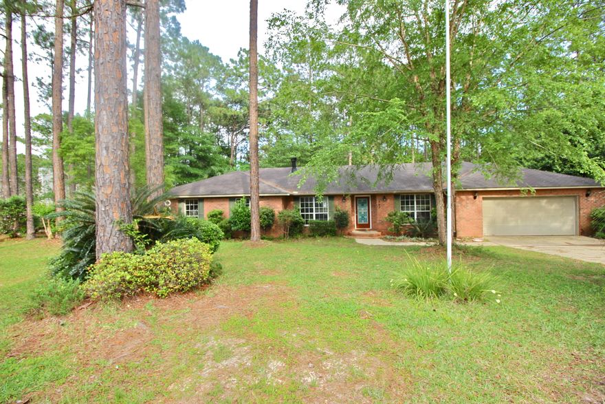 The short sale opportunity you've been waiting for to own in prestigious Pine Shores is here! This well designed 4 bedroom, 2.5 bath home with open living space on a half acre has the most stunningly beautiful landscaped lot. Huge living room with fireplace with custom mantle. Screened back porch plus open deck and storage building out back. New carpet in 2 bedrooms and tile throughout the rest of the home. Formal dining plus breakfast area looking out to the back porch and shaded back yard. Galley style spacious kitchen looking into the back yard, family room as well as dining room. Fourth bedroom could also be a great office/playroom etc. This property needs just a little love to make it a showpiece - a true opportunity to build equity while living in the community everyone loves.