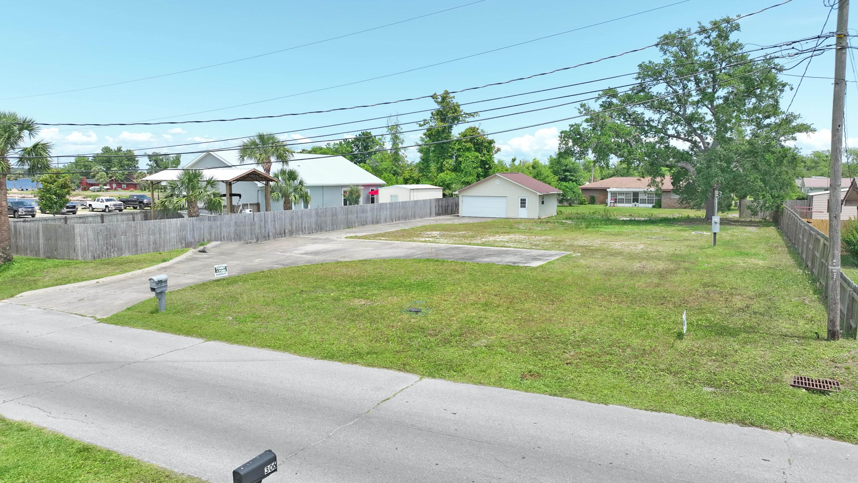307 Michigan Ave, Lynn Haven, 100x150 lot, located steps from the bay as well as Leslie Porter Park with a public boat ramp and enjoy a walk across North Bay on the Bailey Bridge, so much to enjoy in Lynn Haven! The lot is high, has power, water, concrete slab and frame 30x25 building with 2 car garage and additional storage / workshop with power. No HOA, your boat, RV are welcome. Bring your contractor and plan your new build today on what is considered the best vacant lot available in Lynn Haven today!