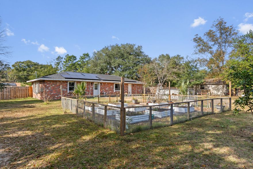 This location qualifies for a USDA loan! Who needs a workshop? This property has a cement workshop with electricity. Escape to your own slice of tranquility at this lovely all-brick home nestled on a spacious, nearly 1 acre fenced lot with a pool! Perfect for first-time buyers, investors, or anyone seeking a peaceful country retreat with easy access to amenities. The kitchen was just updated with new cabinets, quartz counters, all new appliances, and new floors throughout. There is a brand-new septic tank and leach field, new roof, new windows, HVAC-2019, water heater -2017. Solar panels will be paid off at closing (50k). The garage was converted to a bedroom/office, which also has a closet and heat/air ventilation which adds an additional 320 sf. Washer/dryer do not convey. Buyer and their agent should verify all information that is important to them. 