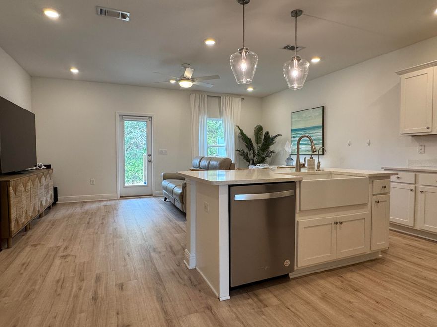 Welcome to refined, low-maintenance living in West Destin's Harbor Place community. Built in 2023 and located in Flood Zone X, this luxury townhome is walking distance to Destin's most iconic dining, entertainment, parks, and more. The extended lot backs up to a wooded area for added privacy, and this is one of the few units with a double driveway. Inside, enjoy the open living area with quartz countertops, LVP flooring throughout (no carpet!), generous 9' ceilings, and recessed lighting. The owners also added a paver patio, pull-down shades, custom shelving in every closet, finished the garage floor, plus many more upgrades to an already-great home. Just 13 miles from Hurlburt Field and Eglin AFB. No short-term rentals. You're going to love being a local!