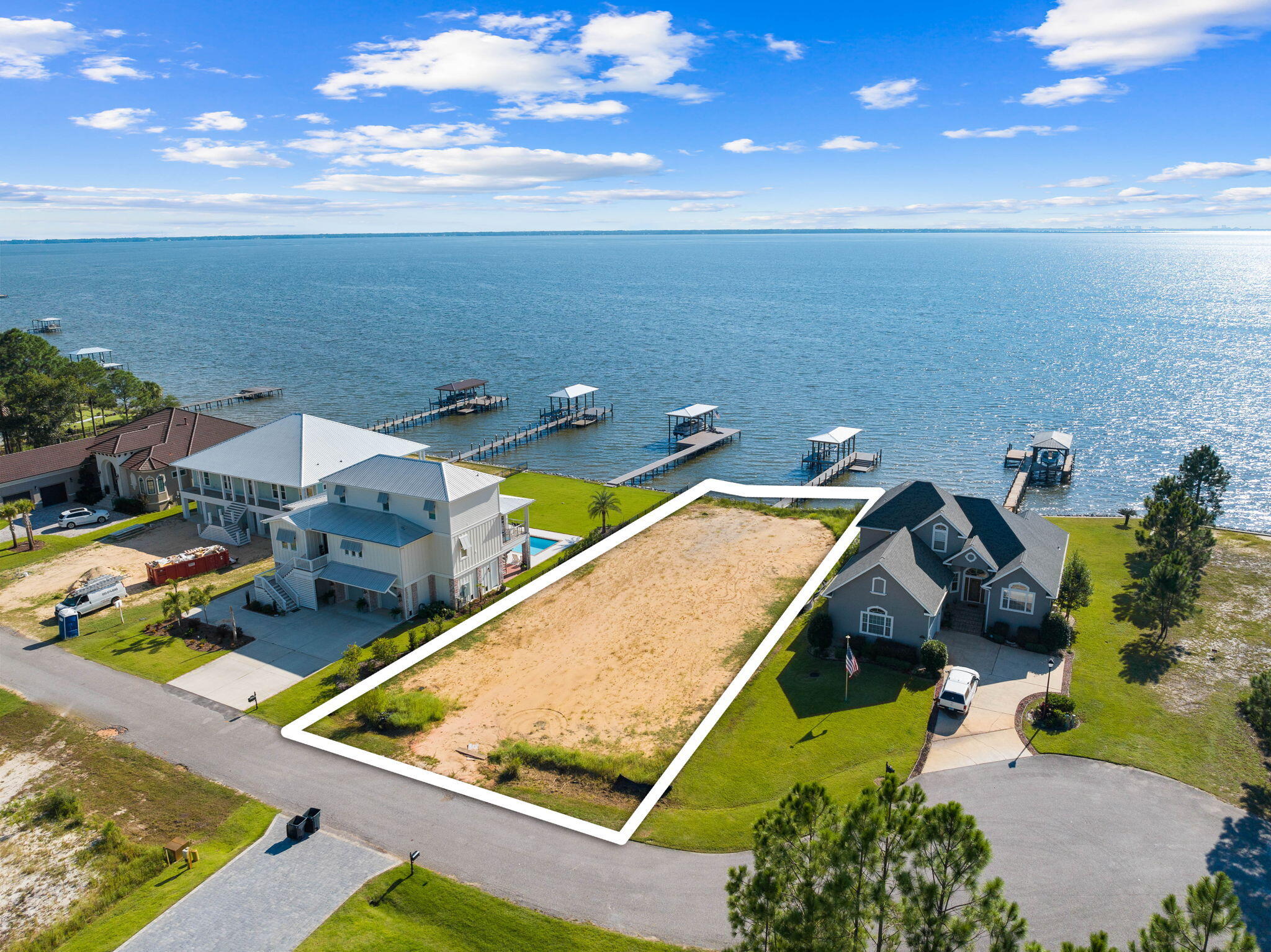 Under Contract - ACCEPTING BACK UP OFFERS. Stunning 0.34 acre bay-front parcel with approximately 80' of water frontage and expansive views of the beautiful Choctawhatchee Bay in Freeport! The hard work has already been done - This cleared, backfilled lot is prepped and awaits your dream home ($20,440.20 clearing and backfill expense already done). Water and sewer connections already paid for ($12,597.70 expense already done). Seawall and new riprap installed. New dock, covered boat slip/lift w/ remote, and kayak launch installed in 2022 with upgraded Thruflow decking ($53,161 expense already done). Walk out is 76' long leading to a platform consisting of a 12'x24' sun deck, 8'x12' long kayak launch, and a covered boat slip at 12'x24'. Enjoy the perk of low HOA fees with no buildout time.