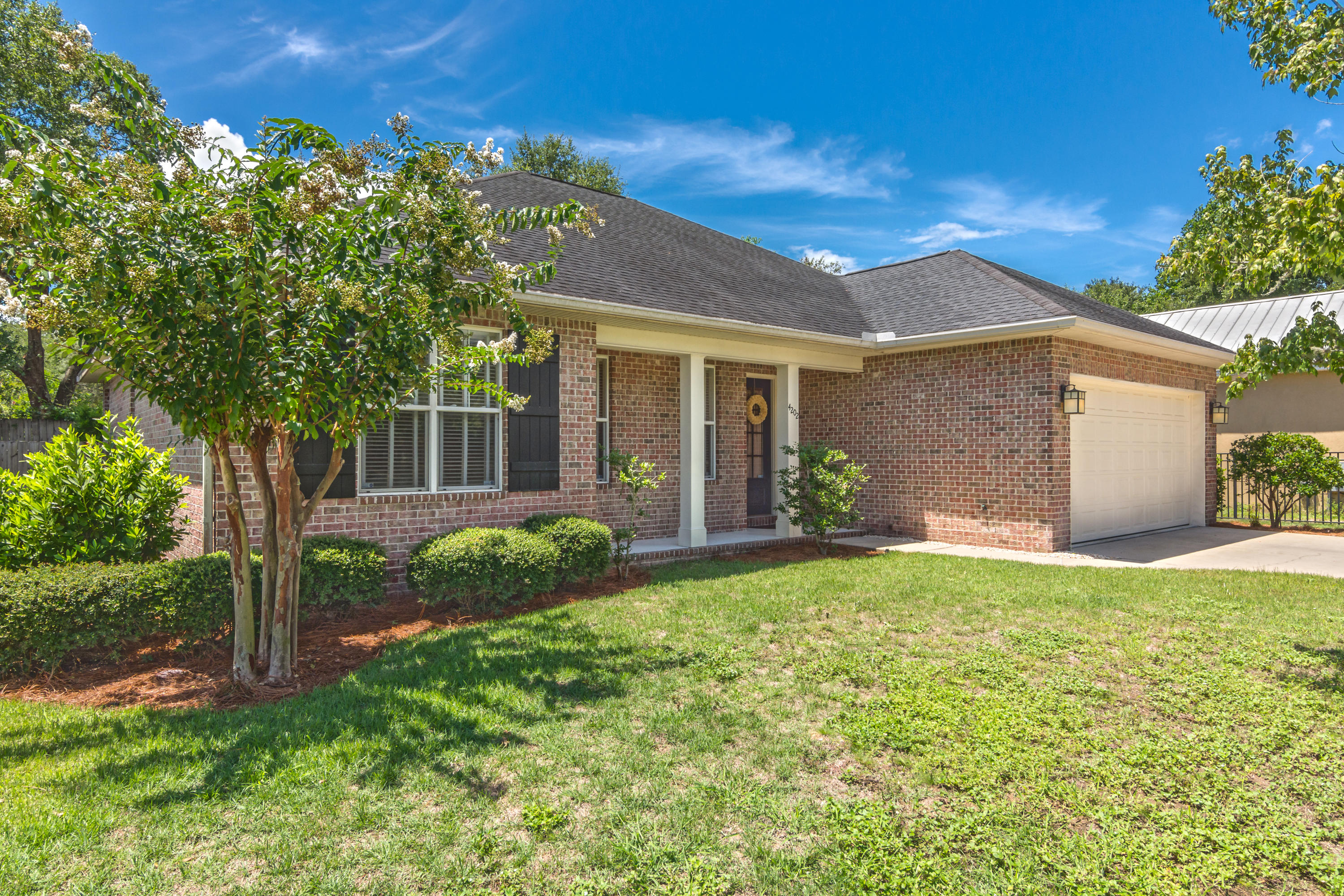 A lovely brick ''Florida Cottage '' style home offering 3 nice size bedrooms and 2 full baths. This home has been loved and cared for. It feels and looks like a new home. The main living area is open to the kitchen, living room and dining area. It's great for family or entertaining. The kitchen has granite counter tops with an eat at bar, stainless steel appliances. A screened in Lanai and back patio brings the outdoors in and offers dining and relaxing space to enjoy your Florida lifestyle. The large master bedroom has an ensuite bath and large closets. The home features a 2 car garage , lg. laundry room, fenced back yard, lawn sprinkler system and recessed lighting. Close to Eglin AFB, Range Rd., Schools, shopping, parks and beaches only mintues away
