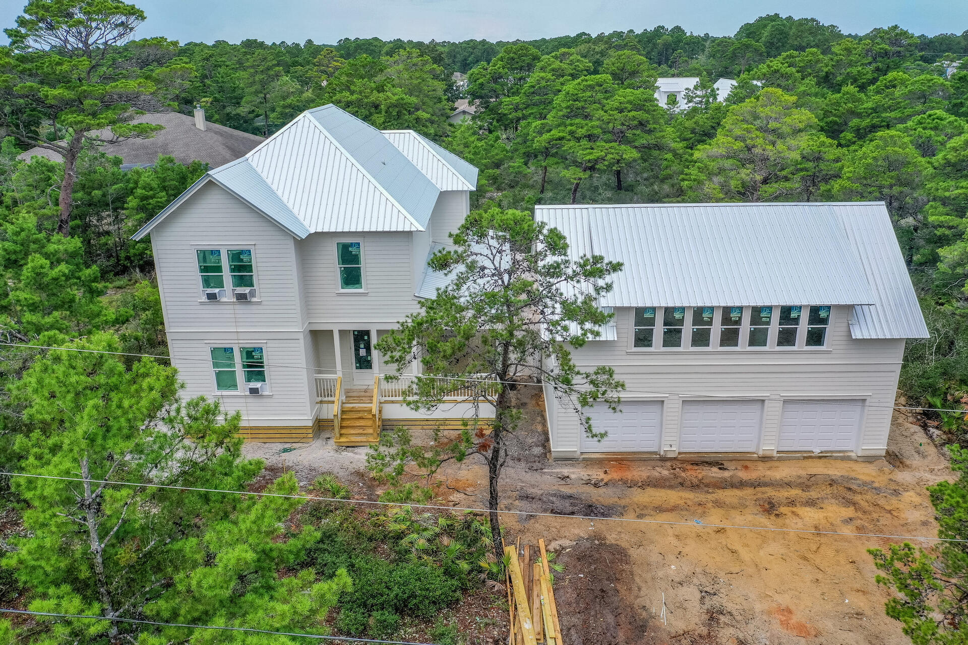 Beautiful new construction home slated to be complete by November. This house has an abundance of outdoor living area, including plenty of covered porches and a swimming pool. The main house has 4 bedrooms and 3 baths for a total of 2,572 sq ft. The detached garage with carriage has a bedroom, full bathroom, living area, and kitchen for a total of 780 air conditioned sq ft. There is even a second laundry in the garage for the carriage above.