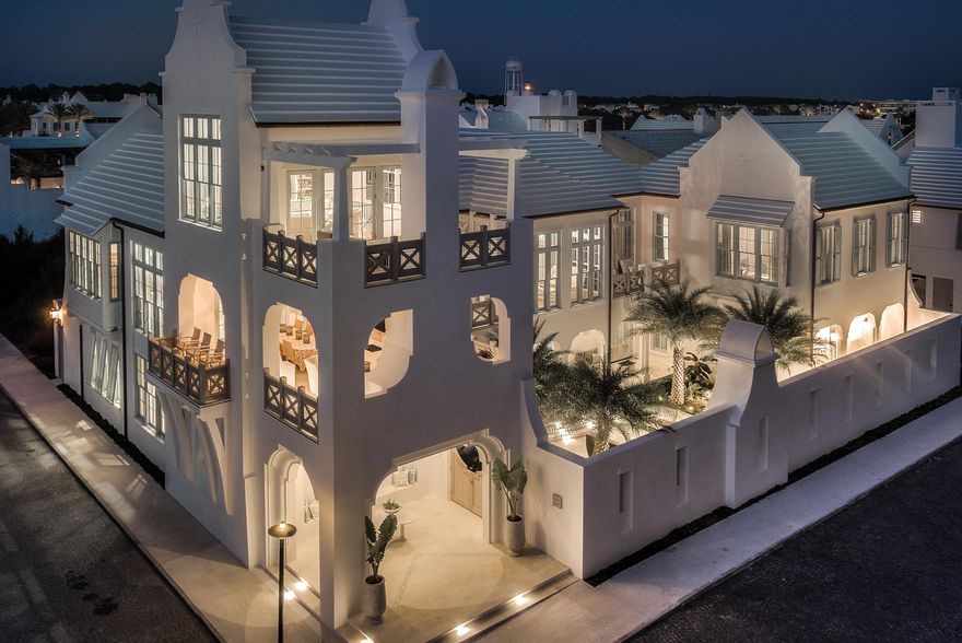 Latitudes & Attitudes is the quintessential Alys Beach home.  This premier, double lot property resides at the corner of the famed South Charles & Sea Garden Streets lending itself to one of the most dramatic elevations Alys Beach offers.  The entry gate opens to a breathtaking courtyard canopied by the majestic Mejool Date Palms with sofas beneath to enjoy the fireplace by night. Entering the home's first floor welcomes you to a secondary family room opening to both the North & South courtyards.  The North courtyard yard with private pool allows for complete privacy for swimming & sunning.  The secondary family room is a gathering space to accommodate the four guest suites at this level. Each of the 4 bedrooms host en suite bathrooms plus one of two powder rooms. Each bedroom is outfitted with its own custom furnishings & design elements. Ascending to the 2nd floor by way of the open staircase brings you to the main living level framed by reclaimed beams set to the apex of the vaulted ceiling. The 2nd floor features views of the Gulf of Mexico from most locations sharing accents of the Medjool Date Palms. The living areas are flooded by natural light cascading through the floor to ceiling windows & transoms making for a peaceful setting.  The living room opens to dual balconies each having sights of the Gulf.  Seating to accommodate family & guests is plentiful. The living area transitions to the dining room & kitchen centered by the professional kitchen's double island capped with Calacatta Marble.  All chilling appliances are Sub-Zero featuring a La Cornue gas range.  Exquisite & extensive cabinetry & hardware provides use of a professional chef for entertaining if desired. The North to South alignment of the kitchen & dining room opens to the dining terrace with all 3 locations having Gulf views.  The sliding doors create connectivity to the terrace providing additional entertaining space for outdoor dining & grilling capturing the gentle Gulf breezes.  The main living terrace boasts a summer kitchen with fireplace & television to be consistent with Alys Beach's iconic indoor & outdoor living concept. Dine outside while watching the sunset sink on the Gulf of Mexico. Sitting above the outdoor terrace is a 3rd story room further emphasizing the livability of the home having its own balcony suspended above the Town.  This space is currently designed as the owner's office that can easily transition to a media room.  Views of the Gulf and the architectural roofscapes of the Town are stunning from this location. Separate from all is the beautifully appointed Master Bedroom private from the other living areas.  This is truly a space of retreat with private balcony, sitting area, and workspace which captures the landscaping below of the courtyard, water views to the South.  His & her closets are generous with custom cabinetry separating the bedroom to bath.  Designer inspired material selections in white palette soften the bathroom to be spa like. Lastly, and unique to Alys, is the carriage house having a private bedroom plus separated bunkroom.  The carriage house is perfect for extended guest visits designed with a full kitchen, dining, & living rooms.  The carriage house sits atop the 3 car garage which has additional parking for 3.  This feature is the only of its kind in Alys. This Domin Bock Architects design is an architectural masterpiece lending itself to full time residency.  This property is a must see.
