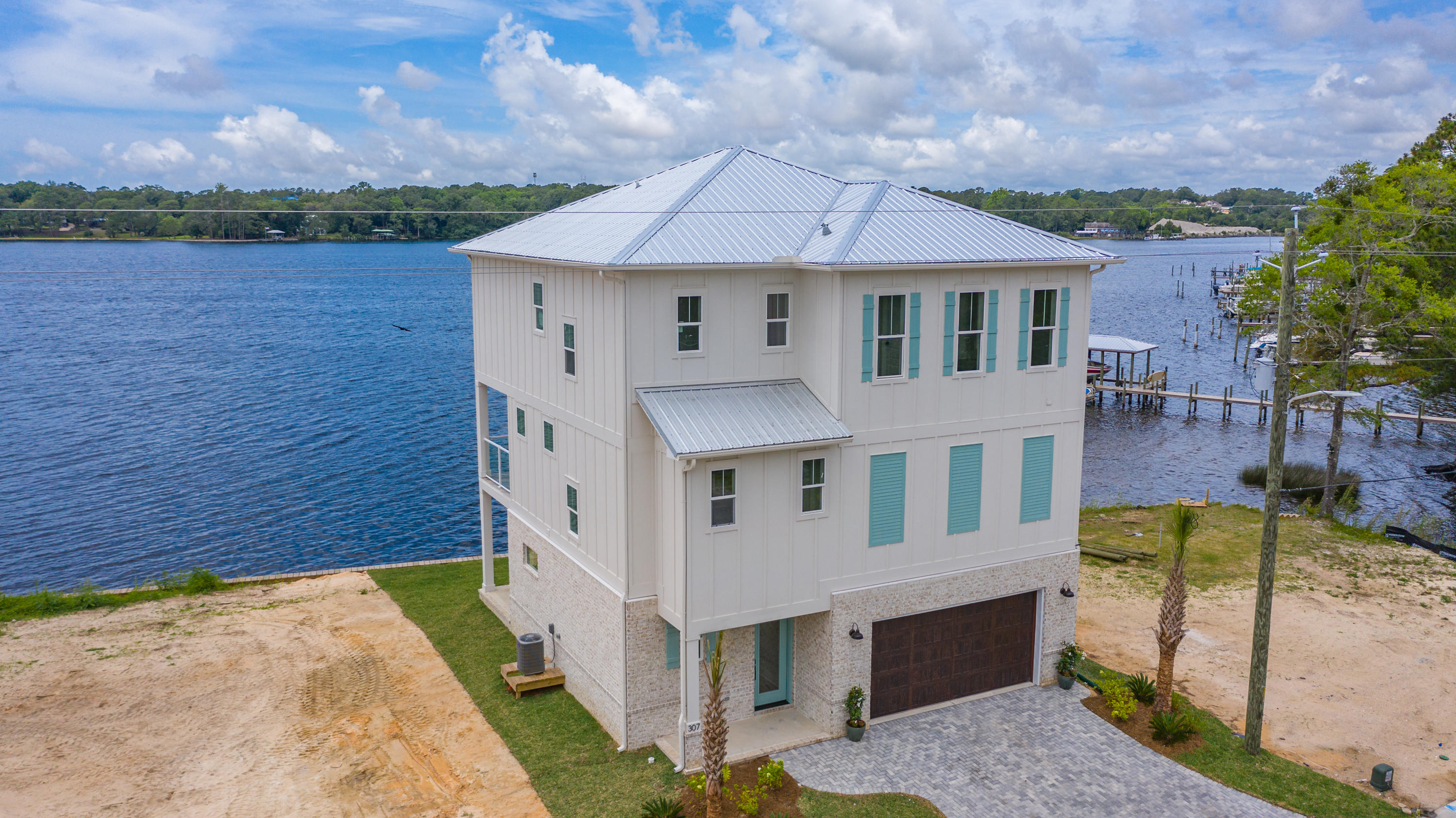 Welcome home to 307 Bayshore Drive. This brand new home is 2021 Parade of Homes Winner, located on the deep water of  Boggy Bayou. This lot has true deep water to accommodate almost any watercraft. The elevator spans all three floors. Tankless Gas Water Heater. 8ft solid core interior doors on the first and second floors. 3 Air conditioners. Spray Foam Ceiling Insulation. Over 700 square feet of porches, all with walnut stained ceilings, and glass balcony railings. 2 Car Garage. Paver Driveway.
