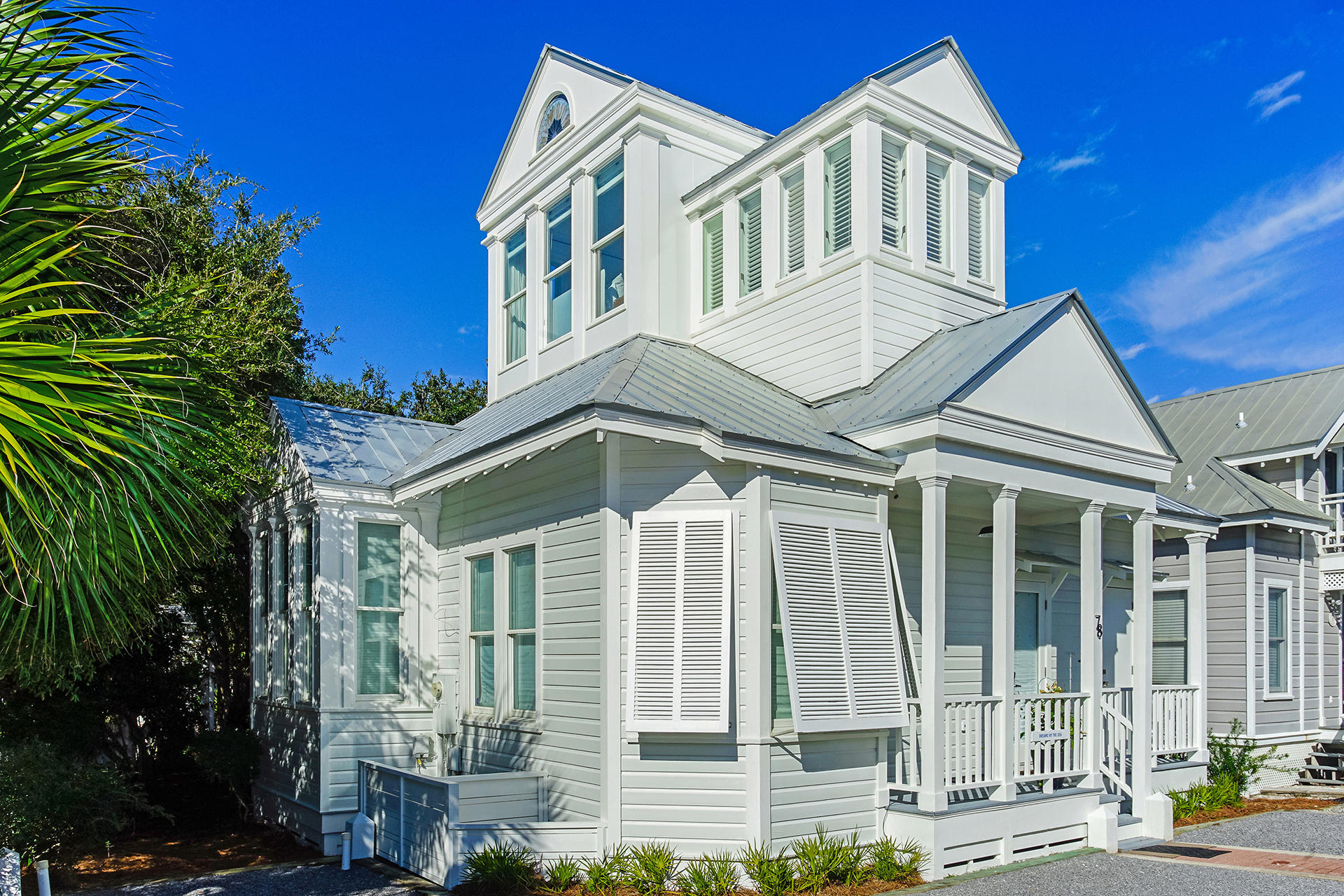 Located along 30A in Seaside, FL, this iconic 2-bedroom + Loft, 2 bath beach cottage offers 1,192 square feet on the corner of 30A  in prime position in Rosewalk, mere steps from the Tupelo Pavilion private beach access. Completely remodeled in 2019, with modern features, this white beach cottage offers quintessential original charm with soaring vaulted ceilings and windows. Originally designed by Robert Orr and Melanie Taylor.Upon entrance to the cottage, the warmth of the hardwood floors envelops you against the coolness of the white walls and high ceilings.