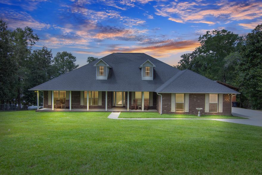 Stunning sunsets await you in your nearly new all brick home on Lake Holley! This 4 bedroom/2.5 baths has an open floor plan with vaulted ceilings, custom cabinets & granite in kitchen & all baths. PLUS a sunroom and expansive deck to enjoy the spectacular view, picture framed by 2 mature oak trees. Lot gently slopes down to the dock & gazebo, all freshly painted. There's also a storage bldg & covered paver patio (addtl separate parking pad also). Back inside, your split floor plan w/ engineered hardwoods & tile, includes a large master with his/hers walk-in closets, shower and jetted tub, double vanity and french door access to the deck. Kitchen has exceptional amount of cabinet and counter space! Spacious breakfast area plus formal dining through french doors (or use that as an office).