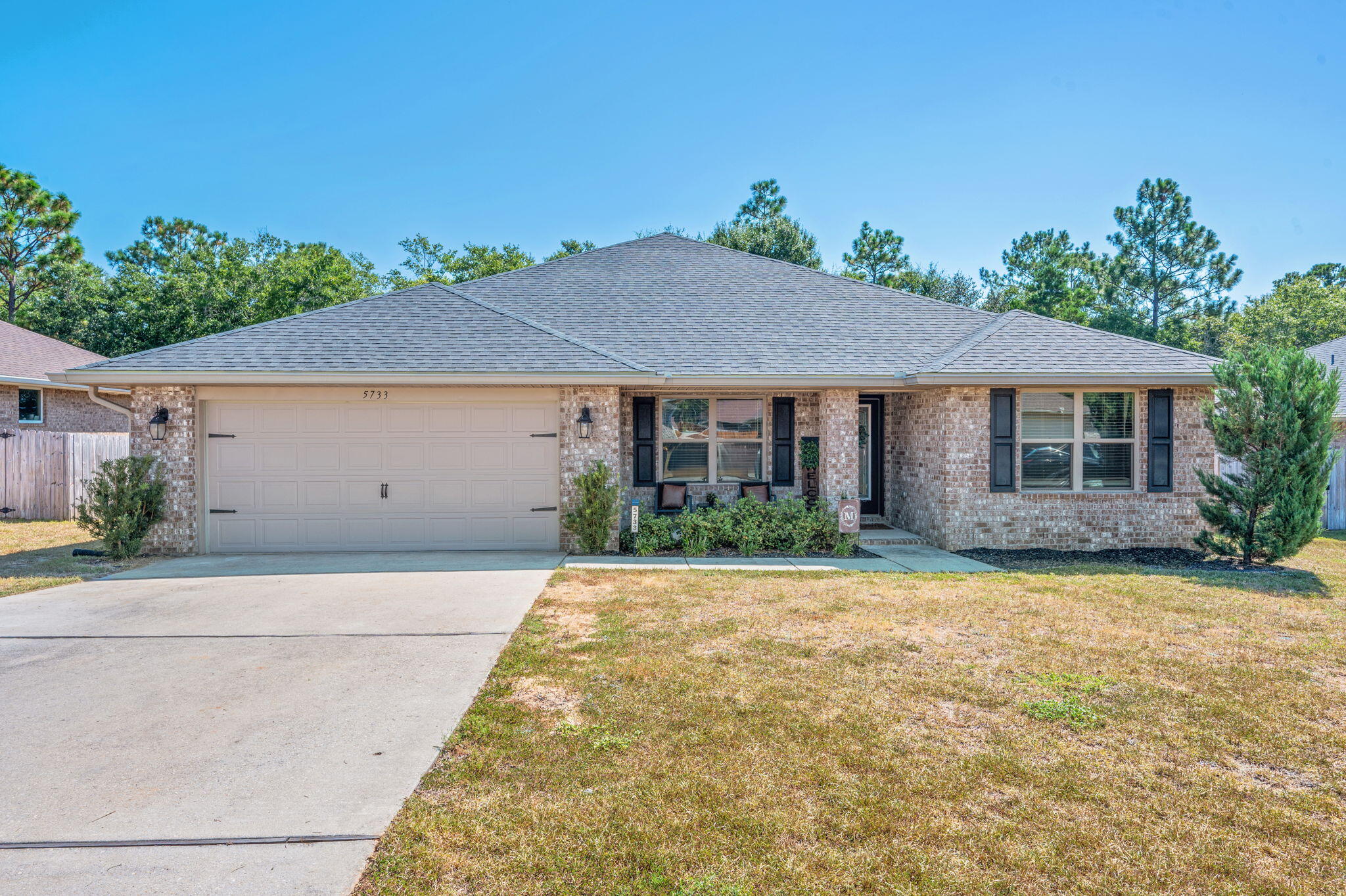 5733 Marigold Loop in Crestview, Florida, is a stunning 3-year-old full brick home that combines modern luxury with comfort. It features 4 spacious bedrooms and a well-designed open floor plan. The interior boasts luxury vinyl flooring throughout, adding durability and style. The formal dining room is perfect for entertaining, while the open kitchen with an island and granite countertops offers a sleek, functional space for cooking and family gatherings. The primary suite includes a private bathroom with a separate tub and shower, providing a relaxing retreat. Outside, the private backyard with an open patio is ideal for outdoor activities and relaxing. The home also includes a 2-car garage and is conveniently located close to shopping and other amenities.