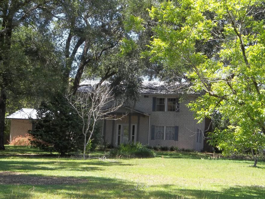 Large 2 story home on 8.7 beautiful acres. Lots of room for the family to roam inside and out. As you enter through the front door you have the stairs leading up to 4 bedrooms, 2 full baths, a bonus room, and the large screened porch.Down stairs is the Livingroom, Dining room, Kitchen, Laundry, 1/2 bath and the Den. The Den boosts  a large gas fireplace for those chilly winter nights and French doors leading out on the covered porch. The property has many beautiful trees, a Fig tree and a Scuppernong/Muscadine grape vine along with many other flowering plants.  There is also plenty of room to store your lawn/farm equipment in the 3 stall pole barn and the small storage barn. While enjoying the serenity of your property, you can also enjoy the views of the neighbor's fields and cattle.
