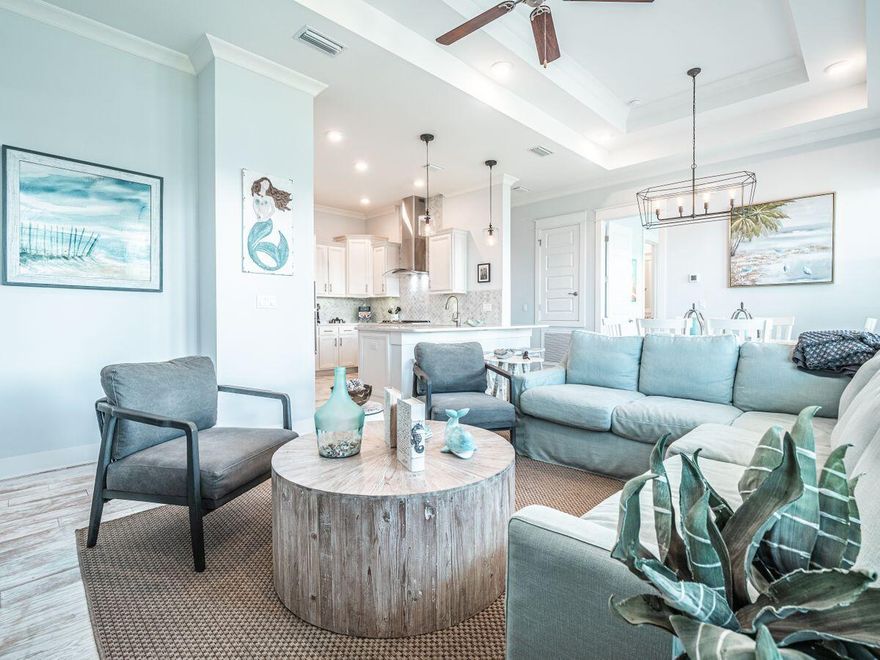 This elegant townhouse style home sits above its attached garage and has a private balcony that spans across the entire facade, offering a place to kick back and relax while enjoying the gorgeous Florida sunsets. Natural light flows through all three sets of south-facing French doors, one of which is accessible through the second bedroom. The open floor plan spreads across the gourmet chef's kitchen, through the dining area and into the living room, all lined with Gulf shore pickle barrel flooring, accented by brushed metal finishes for an extra level of class in this beach themed home. Just across 30A is The Hub, where there are multiple eateries and retail shopping, as well as vendors offering, but not limited to, paddle-board, kayak, and bike rentals.