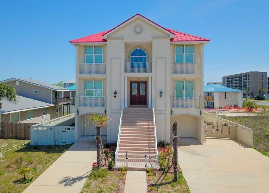 Stunning coastal home with Gulf views, ideally located directly across the street from public beach access. Perfect for a primary residence, vacation home, or investment opportunity.The home features a grand 20-foot foyer with a custom ceiling design, creating a bright and welcoming entry. Interior highlights include a hardwood staircase, elegant chandeliers, and spacious living areas with comfortable finishes throughout.The main kitchen is well-appointed with a large island and breakfast bar, granite countertops, white cabinetry, and stainless-steel appliances--ideal for entertaining. The first floor also offers a secondary living area, a full second kitchen with gas stove, dining space, and two additional bedrooms, providing excellent flexibility for guests or multi-generational livi