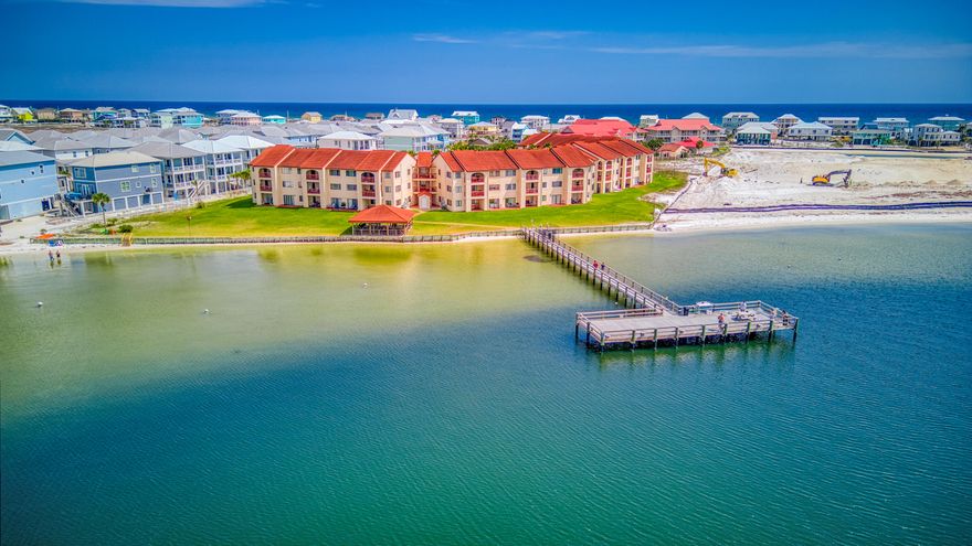 Own your piece of Paradise on Navarre Beach. Elegant and updated turnkey one bedroom one bath at Sunset Harbor. Enjoy sunsets from your covered deck, from the huge community pool or from the private pier on the Santa Rosa Sound.  This complex offers everything you need for a beach getaway.  Plently of parking, community pool, gazebo for gathering and grilling, pier and sandy Sound beach.  Take the stairs or the elevator to this second floor beauty.  Updated kitchen with granite countertops, separate dining area, sink into the new sofa's or step outside and relax on the inviting deck. Back inside rest up in the charming bedroom with a view.  The bathroom boasts a tiled walk in shower.  This unit also comes with a washer and dryer. boasts a tiled walk in shower.  This unit also comes with a washer and dryer.  Just a short walk to the white sands and emerald green waters of the Gulf.  Make this your permanent home or use it as your vacation escape and investment property.  Short term rentals are allowed.