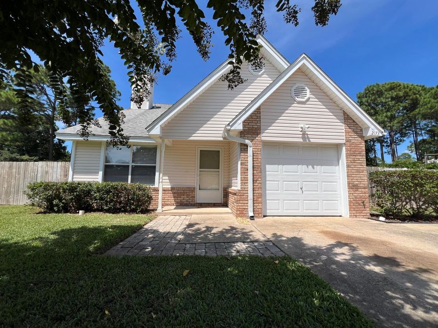 Great Location Close to Beaches, Bases and Shopping!  This beautifully maintained 4-bedroom, 2-bathroom, 1,587 sq. ft. home is Conveniently  Located 3 miles East of the Navarre Beach Bridge on a quiet street.  Step inside to discover a freshly painted interior with Tiled Kitchen and Baths and brand new luxury Vinyl Plank (LVP)  & carpet flooring in the rest of the home.  The welcoming living room boasts an impressive cathedral ceiling and a tastefully tiled fireplace, perfect for cozy evenings. The spacious eat-in kitchen is designed for both functionality and style, featuring an abundance of solid wood cabinetry, ample countertop space, and a large pantry. The bright breakfast nook is has natural light and a new vinyl sliding door that opens up to the expansive, fully fenced backyard.  The first-floor master bedroom has dual closets and an en-suite bathroom that offers a large vanity and modern tile finishes. Upstairs, three generous bedrooms provide flexible living space, including one bedroom with a huge walk-in closet. The additional loft area is ideal as a flex space, suitable for an office, playroom, or extra storage, thanks to its built-in closet. Practicality meets convenience in the extended garage, which is deep enough to accommodate a large truck, and features a recessed area for laundry connections. Outside, the privacy fenced, nearly quarter-acre backyard is a private oasis equipped with a lawn pump and sprinkler system -plenty of room for a pool!  The dedicated RV parking pad with an electric hookup and an extra concrete parking pad at the front of the home add to the property's unique offerings.  Roof is 2005 and Hot Water heater is 2024. In front, there is an extra concrete parking pad that adjoins the super long driveway.  Don't miss out on this exceptional property that checks all the boxes - Schedule your viewing today!