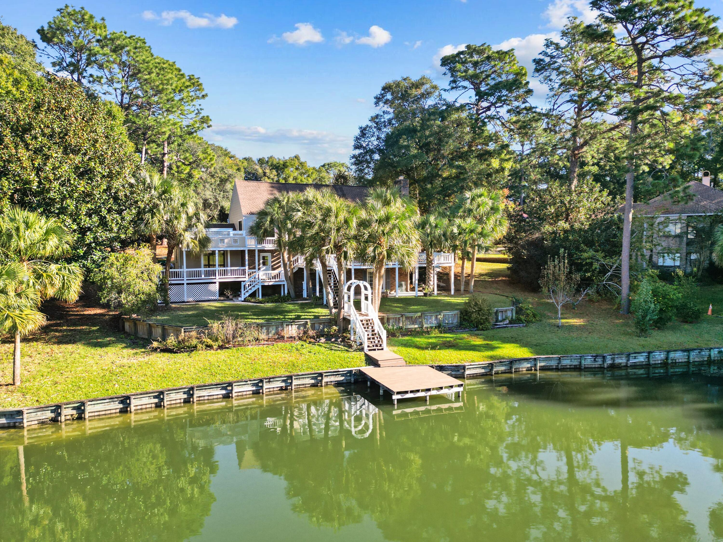 Escape to your own private oasis at this stunning lakefront home nestled on a half-acre lot in the prestigious Le Chateau Rocky Bayou community. Immerse yourself in breathtaking lake and golf course views from multiple decks that wrap around the main level. Tranquil outdoor spaces, mesmerizing water & golf course views with your own private dock. Take out the paddle boards and join dozens of turtles, plentiful bluegill and trophy bass! This tri-level floor plan was designed to bring in the soothing views of the lake and golf course while enjoying the sway of the palm trees with 4 bedrooms and 2 and 1/2 baths. On the main level you'll find a spacious living room with wood burning fireplace with an adjoining open dining room. The kitchen boasts a gas range/oven, all stainless steel appliances, new French door refrigerator (2022) with artisan ice maker. Stainless steel microwave in a closed cabinet, recessed
lighting and a large walk-in pantry. Kitchen has ample room for a table and chairs and abundant natural light. 

Up the first flight of stairs is a full bathroom, guest bedroom with a gorgeous lake view through the custom oversized window, and the master bedroom. The large master bedroom opens to its own private patio built for a full-size hot tub and with amazing sunset views across the lake. There is ample closet space in the bedroom and the freshly remodeled ensuite master bathroom. 

The next flight of stairs brings you to two more guest bedrooms, both with ample closet space. Downstairs boasts a walk-out, fully finished basement which is perfect for a game room or office suite and has a tiled wood-burning fireplace. French doors open to the backyard lake oasis, dotted with peach, pear, and lemon trees and with a monarch butterfly garden.  Plenty of garage space for all your golf course and lake toys in the double garage bays and 240V wiring. New roof and high efficiency HVAC unit installed in 2022. There is a termite bond in effect until Oct 2025. Time to take the lake life to your level. Move in ready. If you're a VA buyer, ask about the seller's VA assumable remaining mortgage.