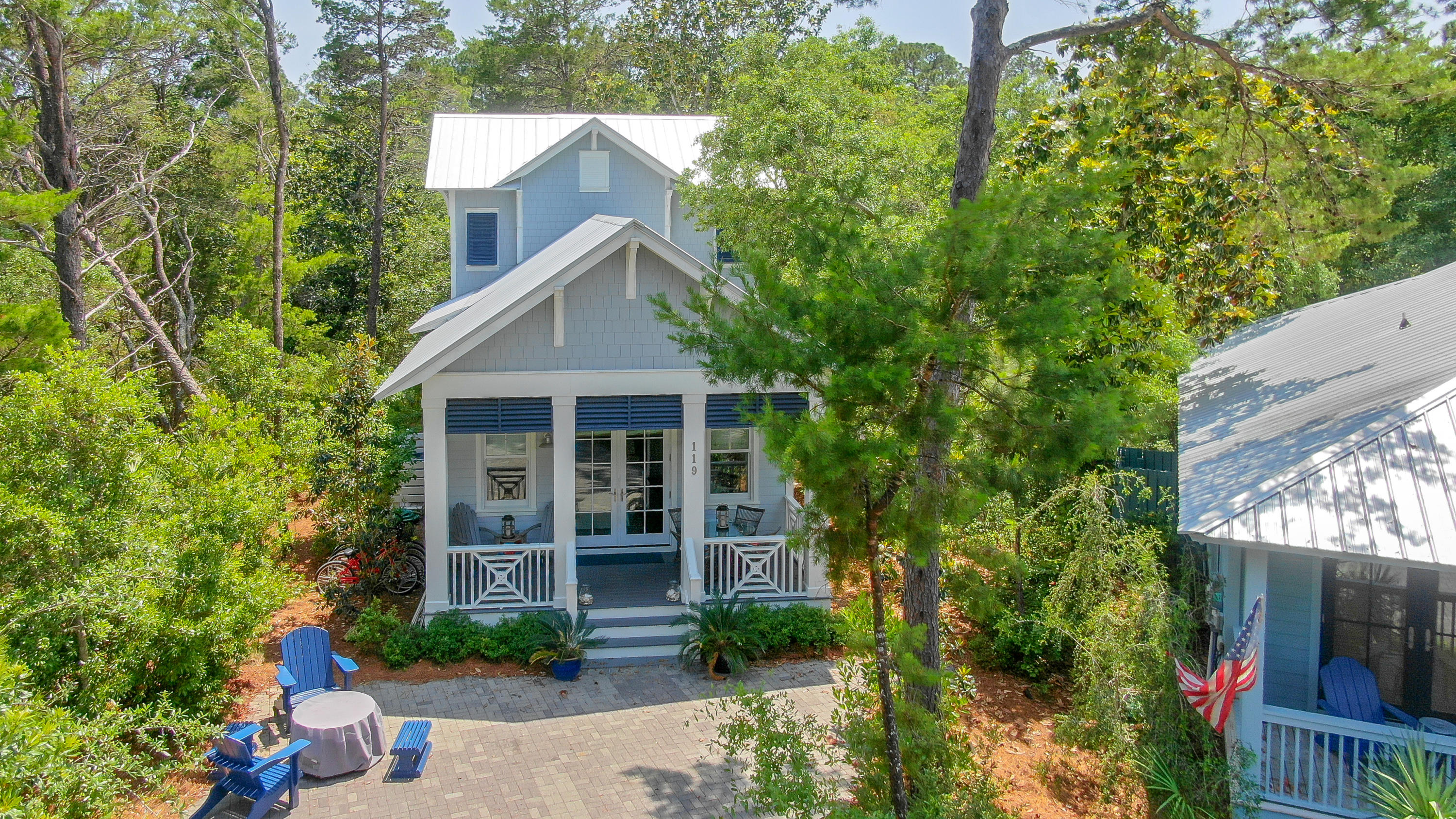 Enjoy the coveted laid-back Florida lifestyle in the Gated Community of The Hammocks at Seagrove Beach. The neighborhood grounds are flocked with trees and located mere steps from Seaside and the white sugar sands of the Emerald Coast.Enter the home on the large front porch, where you can enjoy an evening meal around the outdoor dining area or relax with morning coffee. The rustic hardwood floors warmly invited you into the open concept living and kitchen area for a day of entertaining or intimate get together. The kitchen is anchored by an oversized center island with marble countertops and a large farmhouse sink, plenty of cabinetry for storage and a suite of stainless-steel appliances complete the kitchen.The residence offers