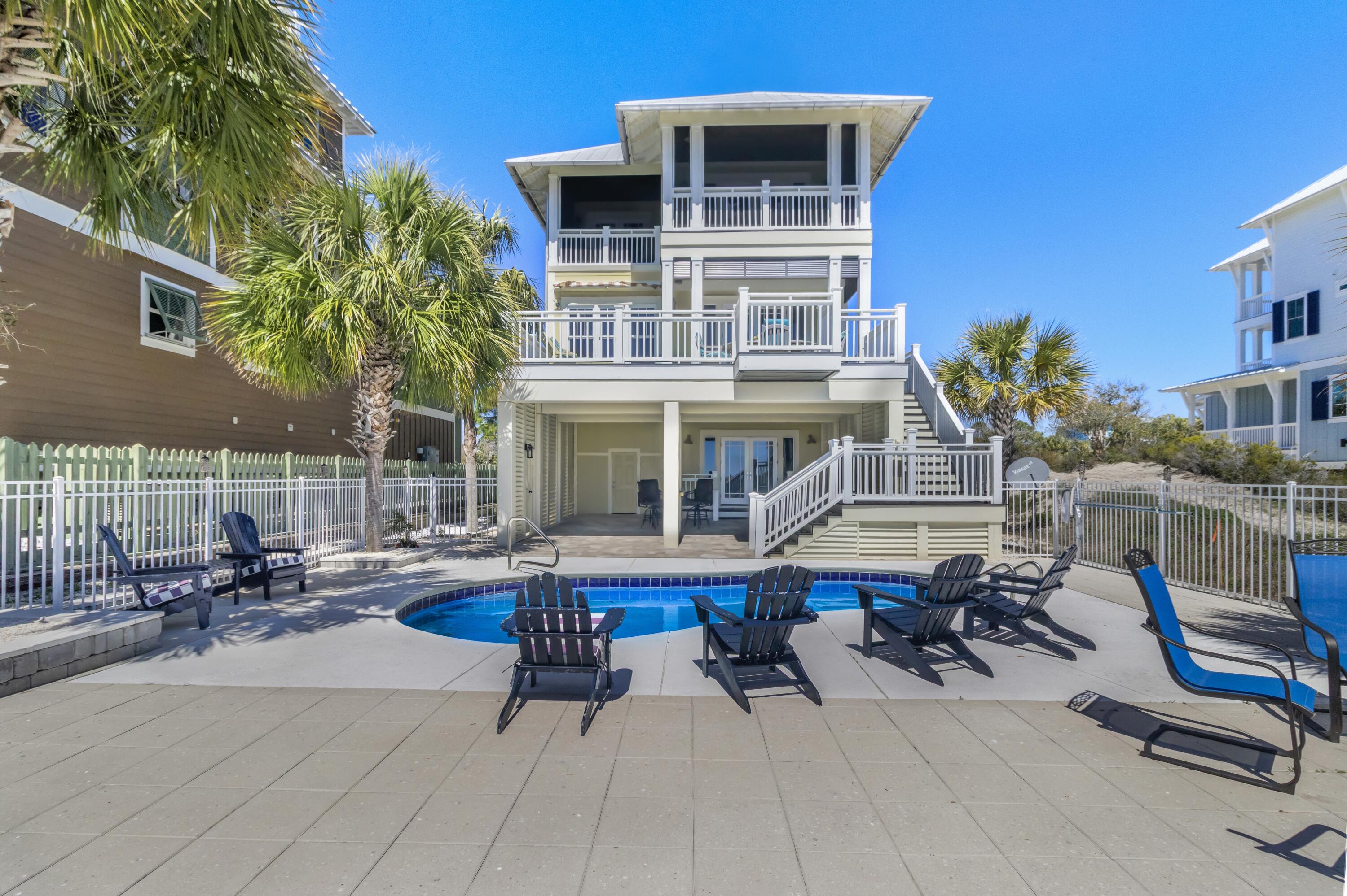 Set on an expansive 1.15-acre gulf-front lot, this extraordinary estate in the gated community of Jubilation offers a level of privacy and coastal luxury rarely found. Thoughtfully designed with breathtaking panoramic gulf views, this five-bedroom, five-bathroom residence spans over 3,200 square feet of refined living space, seamlessly balancing sophistication with comfort. Every bedroom features a private balcony, creating a personal retreat with stunning vistas of the Gulf of Mexico. The heart of the home is a chef's kitchen, meticulously designed with high-end Sub-Zero appliances, a Wolf gas range and custom lighted cabinetry that adds both elegance and functionality. An oversized island with quartz or stone countertops provides ample space for cooking and entertaining, while a dedicated coffee and wet bar includes a 140-bottle wine cooler, ensuring a seamless hosting experience. The open-concept living and dining areas are bathed in natural light, offering unobstructed gulf views through expansive windows. Each of the five bedrooms is generously sized, with private access to gulf-facing balconies that invite the soothing sounds of waves and stunning sunsets into everyday life. The primary suite offers a serene escape with a spa-like ensuite bath, featuring premium finishes and ample storage. Designed for outdoor enjoyment, the property features a private heated pool overlooking the gulf, surrounded by professional landscape lighting that enhances the ambiance after sunset. A private boardwalk leads directly to the sugar-white sands, ensuring effortless access to the beach. The home's exterior has been meticulously maintained, with recent updates including a fresh coat of paint, a newly redone driveway and enhanced landscaping. Located in one of the most exclusive beachfront communities, this estate offers an unparalleled coastal lifestyle. The gated setting ensures security and seclusion while still providing easy access to the area's renowned dining, shopping and outdoor recreation. Whether as a primary residence, a luxurious second home or a high-end vacation rental, this property presents a rare opportunity to own a piece of paradise on the gulf.