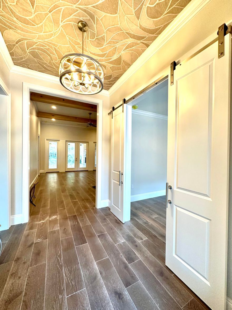 NEW CONSTRUCTION! 5 Bed, 3 bath! Gated! AWARD WINNING BUILDER! OUTDOOR FIREPLACE! This STUNNING home is quality built and loaded with details that are sure to impress. You'll be wowed as soon as you step into the entryway and notice the beautiful ceiling detail, the expansive floor plan with amazing flow, tall ceilings, wood beams, 8 ft doors throughout, and a kitchen that is a chef's dream. The massive 12 ft island is the perfect complement to the custom wood range hood that hangs above the 36 inch gas kitchenmaid range. All high end appliances, beautiful lighting, hardwood flooring, French doors leading to the covered rear porch that is complete with a bricked gas fireplace and a stained tongue and groove ceiling! The master bedroom features beams and a shiplap focal wall, and the en sui bath features a freestanding soaker tub, large custom tiled spa shower, double vanities with lots of cabinetry and framed mirrors, and a massive walk in closet with built in shelving. Just to the right of the entry is an office /5th bedroom flanked by double barn doors,  The oversized laundry features cabinetry, shiplap mudroom drop zone and a large pantry with wood shelving, The 2 additional bathrooms in this home are equally spa like, one has a fully tiled curbless shower with frameless glass and the other feature a tub with a fully tiled surround and built in niche. If you are looking for details and high quality contraction, THIS is it! Nestled on a quaint cul de sac in popular North Crestview, this home is estimated to be complete by mid February. Act fast because this home will NOT last!