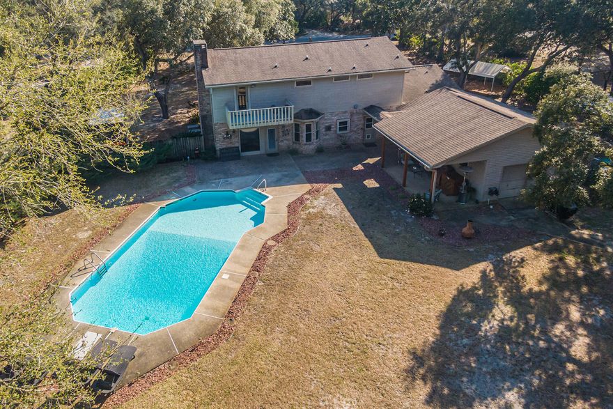 Seize this rare opportunity to claim a fantastic 5 bedroom, 4 bathroom home on a sprawling 1.02 ACRE lot in Bluewater Bay! Located on Springacres Cove, this fine property is subject to no HOA restrictions. Numerous recent improvements include 3 complete bathroom renovations, removal of an interior wall to create a more spacious family room, and updates to flooring, lighting, plumbing and hardware fixtures. On the main level, find a trio of gathering spaces - a formal dining room, an eat-in kitchen with ample cabinetry, granite counters and stainless steel appliances, and a family room with wet bar and fireplace all overlooking the POOL. A perfect mudroom/landing zone and convenient full bathroom welcome you in from the detached garage and backyard oasis. Through the mudroom lies a massive