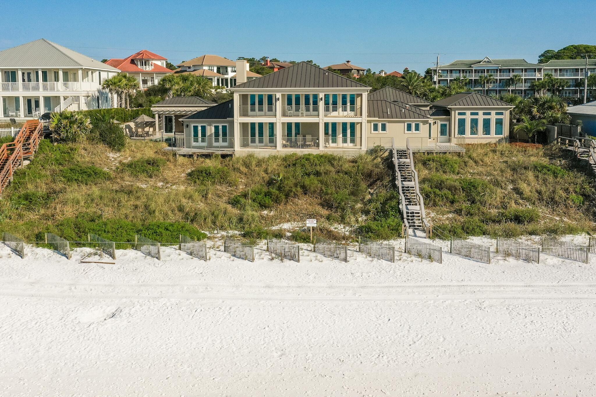 Unlike any other...This premier residence sits directly on the Gulf of Mexico, boasting 150 linear feet of pristine beach frontage on 1.2 acres. Located in walking distance to the restaurants and shops at Gulf Place in Santa Rosa Beach along Scenic Hwy 30A, this spectacular, sprawling compound features extraordinary views from the living room, dining room, kitchen, five bedrooms,  office, two 12'x38' covered porches, and a pool.  Stunning views immediately awaken your senses as you enter into the open concept living room, dining room, and kitchen with beautiful wood beams, travertine floors, and a gas fireplace. Next, walk outside to a large covered porch, which is just steps away from the white sandy beaches and emerald waters uniquely found in the Panhandle of Florida.