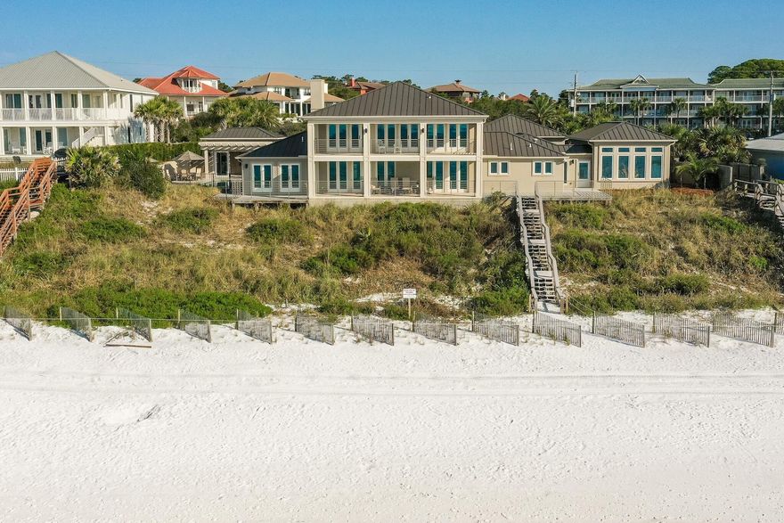 Unlike any other...This premier residence sits directly on the Gulf of Mexico, boasting 150 linear feet of pristine beach frontage on 1.2 acres. Located in walking distance to the restaurants and shops at Gulf Place in Santa Rosa Beach along Scenic Hwy 30A, this spectacular, sprawling compound features extraordinary views from the living room, dining room, kitchen, five bedrooms,  office, two 12'x38' covered porches, and a pool.  Stunning views immediately awaken your senses as you enter into the open concept living room, dining room, and kitchen with beautiful wood beams, travertine floors, and a gas fireplace. Next, walk outside to a large covered porch, which is just steps away from the white sandy beaches and emerald waters uniquely found in the Panhandle of Florida.