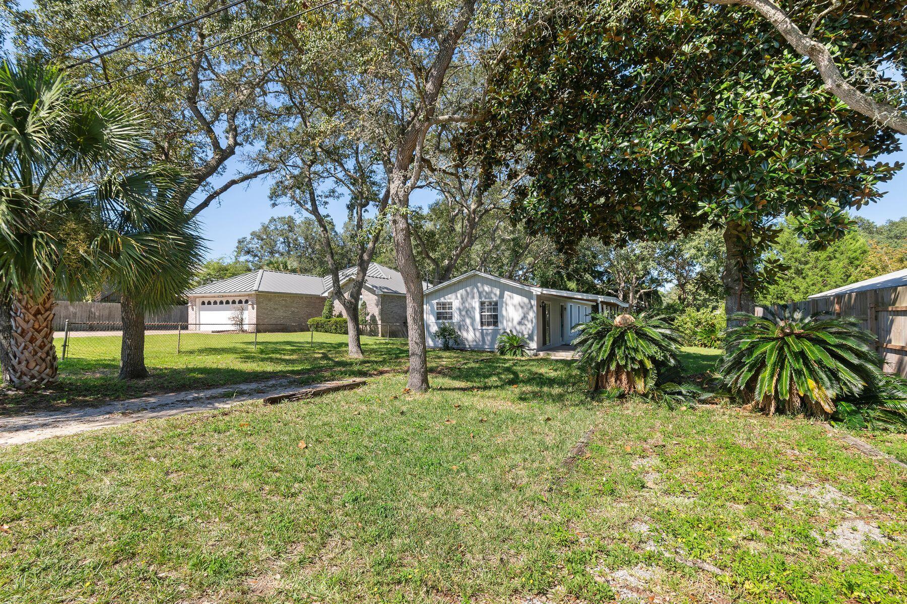 Positioned in the heart of Destin, this home offers both opportunity and convenience with a location that's hard to beat. Located just two blocks from Destin Elementary School, the setting is ideal for families. Currently, Destin Elementary School is undergoing an incredible expansion project that will allow 5th graders to return to the school. Destin Little League is also less than a mile away, and here you can experience their annual parade to kick-off the little league season. Only half a mile from Joe's Bayou and the public boat launch, the setting is perfect for boating or fishing enthusiasts. Parking your boat here is no problem. Set on nearly a quarter-acre with no HOA, the property features mature oak and magnolia trees and a fenced backyard perfect for gatherings, swinging on a tree swing in the shade, or quiet evenings outdoors. Inside, fresh vinyl plank flooring provides a clean foundation to focus on additional updating to make it your own. Currently enjoyed as a second home getaway, it's ready for a buyer who is looking for a manageable project. Priced under $300,000, this is a rare opportunity for this price point in Destin. Even better, the surrounding area is poised for growth with a City of Destin project underway to enhance Joe's Bayou Recreation Area with expanded boating access, new restroom facilities, a fishing pier, walking trails, and more. Nearby Mattie Kelly Park and Nature Walk will also see improvements, including additional boardwalks and wetlands enhancements. With location, value, and future community amenities, this property holds remarkable potential for a new owner ready to add their own touch. Priced under $300,000, this is a rare opportunity for this price point in Destin. Even better, the surrounding area is poised for growth with a City of Destin project underway to enhance Joe's Bayou Recreation Area with expanded boating access, new restroom facilities, a fishing pier, walking trails, and more. Nearby Mattie Kelly Park and Nature Walk will also see improvements, including additional boardwalks and wetlands enhancements. With location, value, and future community amenities, this property holds remarkable potential for a new owner ready to add their own touch.