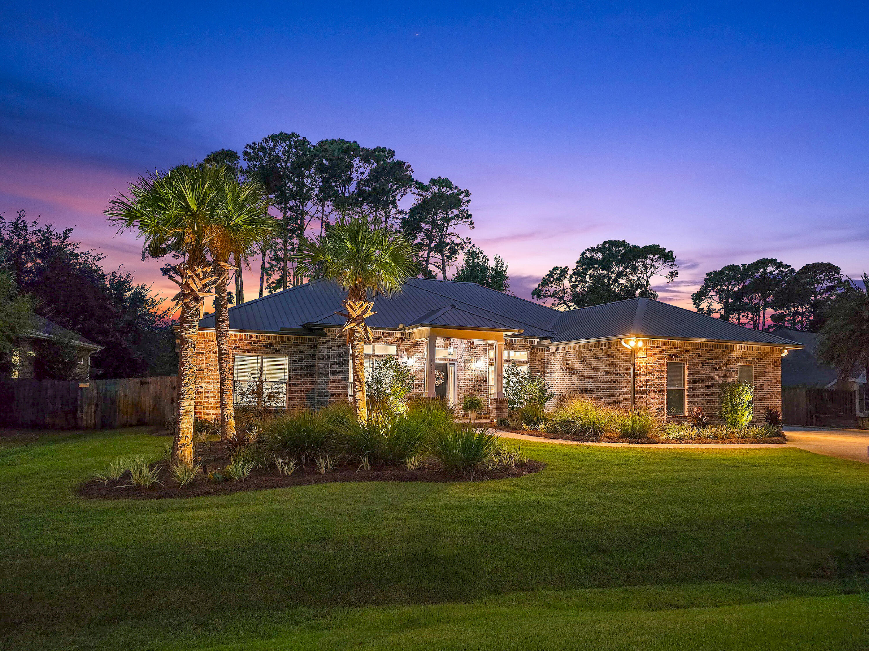 Welcome to 1361 Forest Shore Drive, a beautifully maintained all-brick home in a quiet setting in Miramar Beach near Paradise Park and Choctawhatchee Bay. Built in 2014 and thoughtfully updated over the past two years, this three-bedroom, two-and-a-half-bath residence with an additional dedicated office offers timeless curb appeal, and modern upgrades.The home's open-concept design features high ceilings, abundant natural light, and a split-bedroom floor plan that provides both comfort and privacy. The spacious kitchen is ideal for everyday living and entertaining, complete with stainless steel appliances, granite countertops, a center island with bar seating, and ample cabinet space. It flows seamlessly into the dining area and living room, where French doors open to the backyard.... and a newly added electric fireplace creates a cozy focal point.
The private primary suite is tucked away and features peaceful backyard views, a generous en suite bathroom with double vanities, a separate shower, and two large walk-in closets. Two guest bedrooms are located on the opposite side of the home, separated by a full bathroom and a powder room for guests. The dedicated office space with French doors makes working from home both functional and stylish.
Recent updates to the home include a new 2025 HVAC system, new whole-house generator, remodeled kitchen, dining room, primary bath, family room, laundry room, closets, and hardwood floors in the bedrooms. The garage has been updated with a new reinforced garage door for added storm protection, built-in cabinetry for additional storage, epoxy floors, and new attic access ladder. The exterior of the home has a Ring Doorbell system for added peace of mind and new brick pavers define the entry. Brick pavers have been added to the rear porch along with a pergola and outdoor fireplace. The landscaping too has been renovated with new sod and outdoor low voltage accent lights.
With its metal roof, attractive brick exterior, and no HOA restrictions, this home offers long-term value and lifestyle flexibility just minutes from the sugar-white beaches, dining, shopping, and golf courses that make Miramar Beach so desirable. Whether you're looking for a primary residence or a second home along Florida's Emerald Coast, 1361 Forest Shore Drive is a must-see.