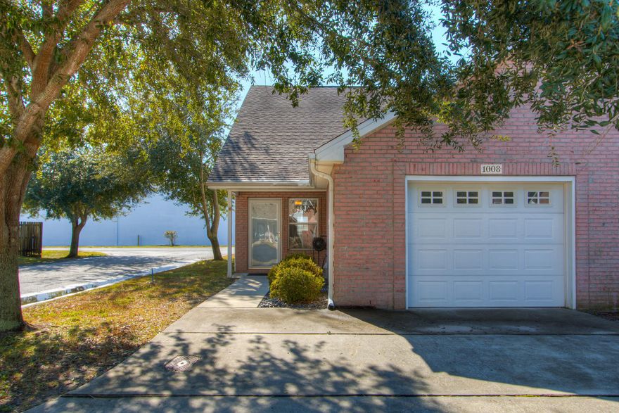 Welcome to Yacht Club Oaks! This end unit has been beautifully updated with wood look tile throughout the bottom floor leaving square tile in the kitchen and bathroom. The kitchen received stainless steel appliances, backsplash, and a beautiful brick detail on the breakfast bar. Outside you'll enjoy a privacy fenced back yard with plenty of room to make cozy outdoor living area.