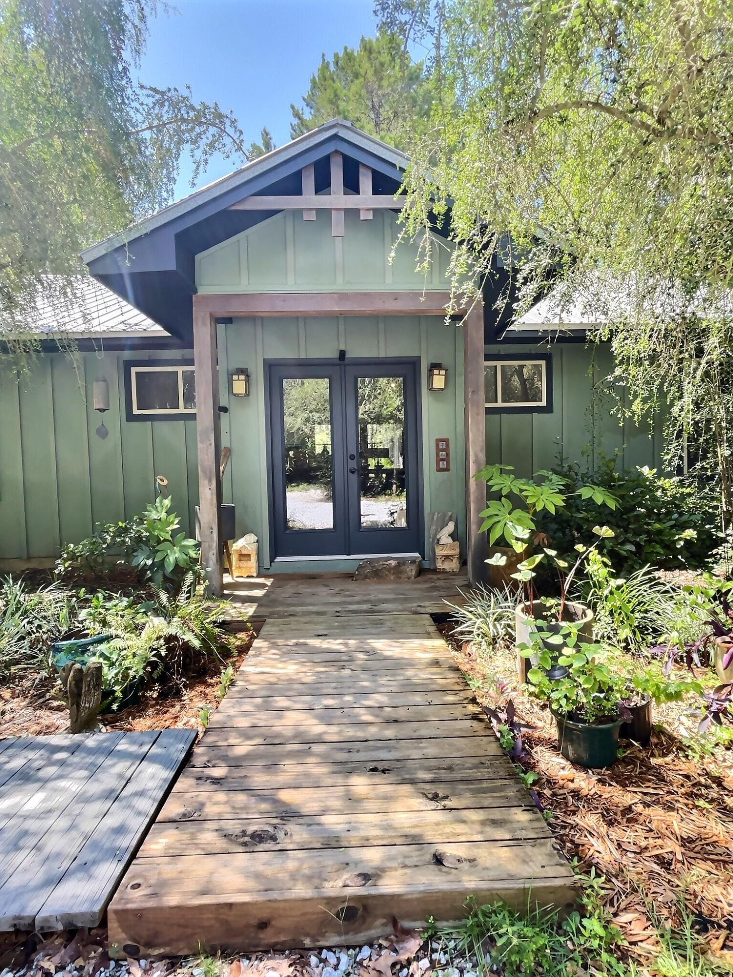 Peaceful, beloved 'one of a kind' custom Artisan home, well cared for; designed and built by the owner, Marti Schmidt, is tucked away in one of the most desirable and quiet areas of the authentic Point Washington Forest. The backyard boundary is 372 ft of the Forest. Nothing but nature surrounds this home. The large custom windows and cathedral ceilings allow for ample natural light throughout the home. There are hand-painted Raku Tiles around the fireplace and soaking tub. There are three stunning bedrooms, each with a private bath. The massive primary bedroom has a custom soaker tub and walk-in closet. There's a private screened porch for coffee or wine. Inspired by Frank Lloyd Wright, when designing the home, the Artist owner included custom walnut/maple furniture and cabinets built