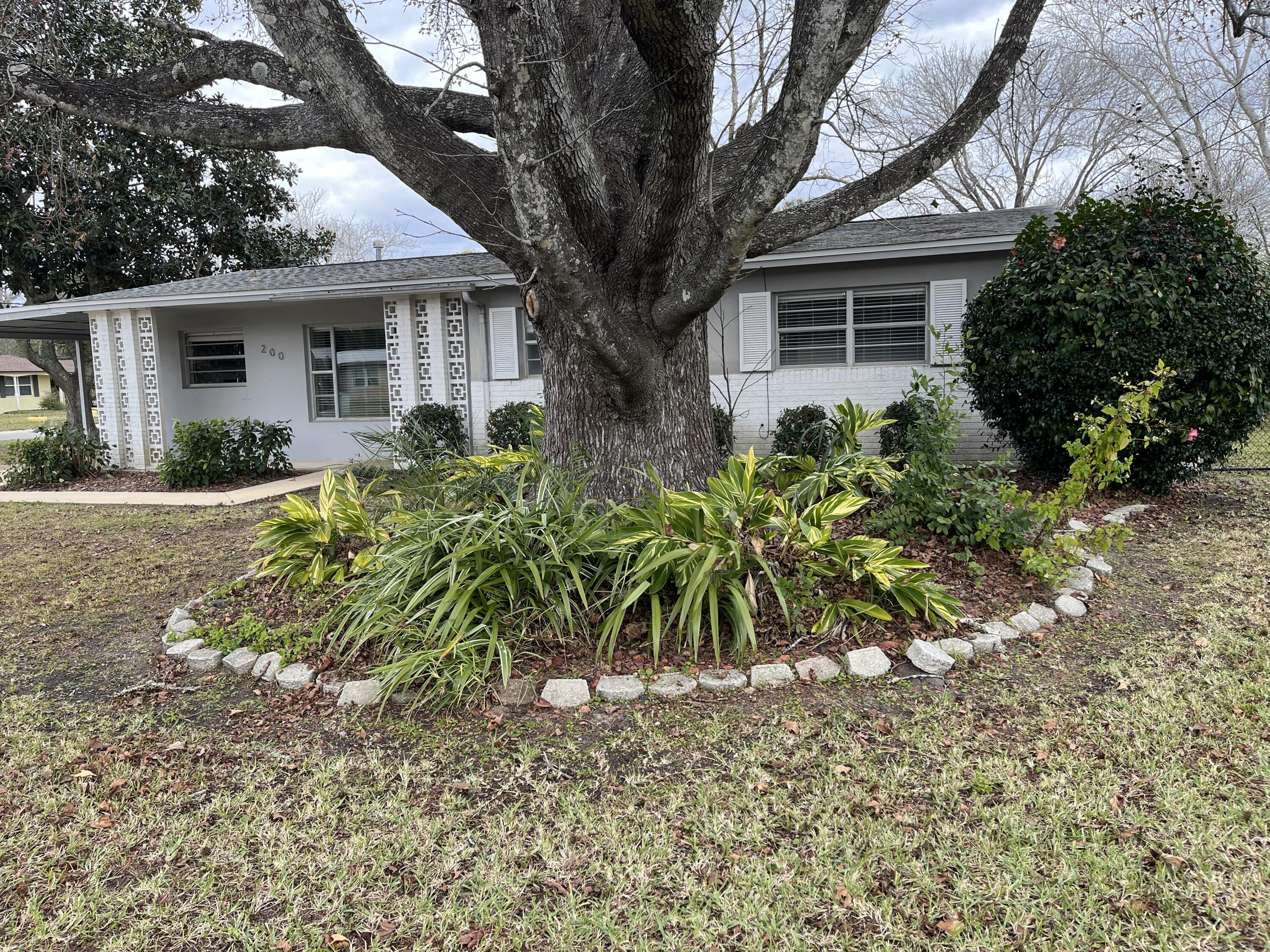 This subdivision is unique in that it has sidewalks on both sidesthroughout the subdivision and is the closest to Hurlburt AFB and 98.   This home has been upgraded to reflect more modern times with an open floor plan.  Carport with workshop area/storage enclosed with electricity.  Fenced in backyard with double gates. Inside is open for entertaining.  Three bedrooms are nice size. The home was in the rental market and easily got $1500.00 per month. Cinder block homes have survived hurricanes in the past.