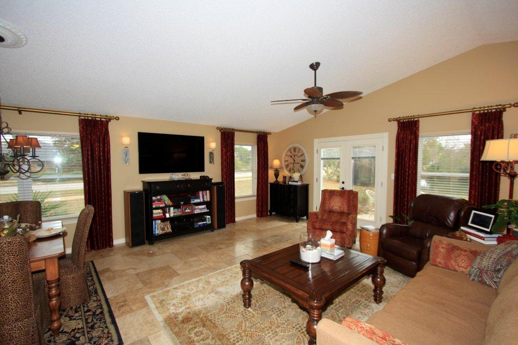 Beautifully decorated and exceptionally well-maintained property for your next home!Brick and stucco home on a corner lot has lake view. House has Pella windows upgrade; light fixtures, fans, oiled-bronze hardware, travertine flooring are other improvements. A new owner will also enjoy 2-zone surround sound, custom Levolor blinds, and open space. Great room area has natural light, stainless steel appliances, pendant lighting over breakfast bar. Split floor plan with master suite separate from other bedrooms. HVAC replaced in 2013.House also has hurricane shutters for window openings. Neighborhood is conveniently located and offers a pool and tennis court. (Buyer to confirm all fees, measurements, and other information. Washer and dryer do not convey.)