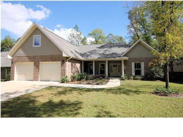 Beauty & function meet perfectly in this gorgeous 5 bedroom, 4 1/2 bath home located in a great neighborhood. Convenient to bases, schools shopping and just a quick 30 minute drive to the most beautiful sugar white beaches around. The community is small and charming and each home is unique with plenty of charm and character. There's a large covered front porch with columns making this perfect for rocking chairs with its southern charm. You will just love this home's open floor plan that is elegant, yet inviting. The Formal Dining Room is to the left when entering, with its beautiful trey ceiling, custom lighting and then opens up to the large family room. The Breakfast area in the kitchen looks out over the back yard & porch and there is a large island and breakfast bar that opens to