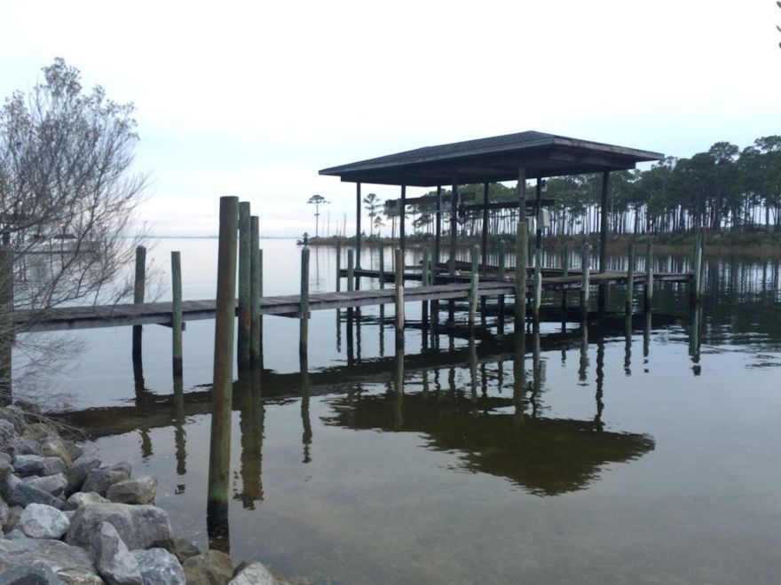 This 1.32 acre, bayou-front parcel is perfect for any fishing or boating aficionado! It is the ONLY waterfront property available on Shirks Bayou! Prime location is only one of the features that make this land an unprecedented opportunity. Build your dream home and own an incredible view that stretches all the way to Destin! This property boasts a seawall, expansive deck with lift, water and electric hook up already installed, deep and protected water, and lots of privacy. Don't miss your LAST CHANCE to own this stunning and opulent view!