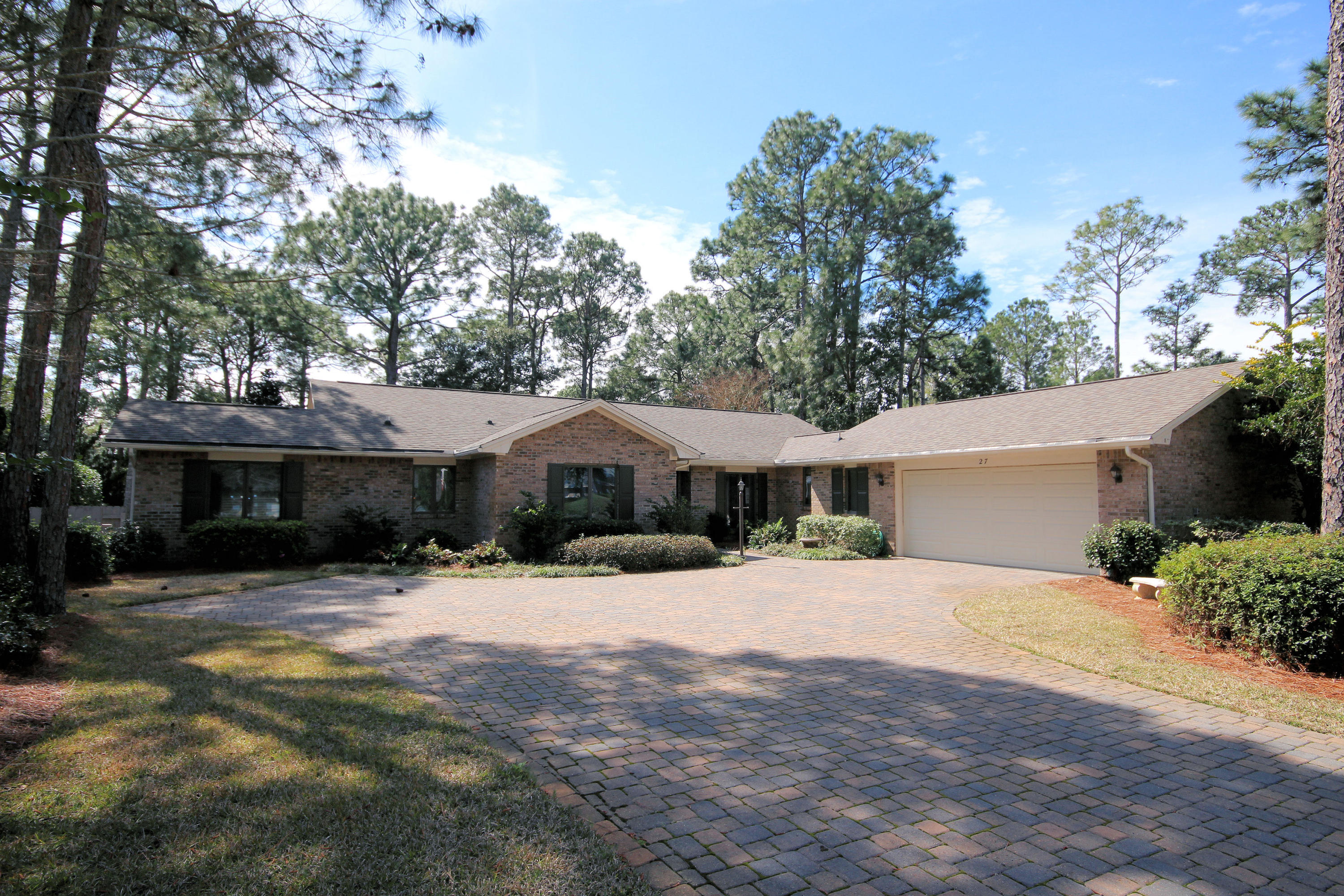 Come see this beautiful golf course home, in gated Southwind, in Bluewater Bay, all on one level, with a fabulous heated swimming pool. The open, light and airy family room with fireplace, has a vaulted wood ceiling with and built in bookcases. It opens to the dining room. The large master bedroom has a nice master bath with garden tub, separate shower, sit down vanity, and walk in closet with built in organizers. Both bathrooms have new plumbing fixtures, lights, and energy efficient toilets. The nice kitchen features wood floors, built in desk, breakfast bar, and breakfast area. There is a sprinkler system on a well to water the yard. There is a nice sun room on the back of the house opening to the pool, as well as a wonderful covered parch on the back. This home will not last long! Buyer to verify all dimensions important to them. House plans show square footage at 2319 including sun room.