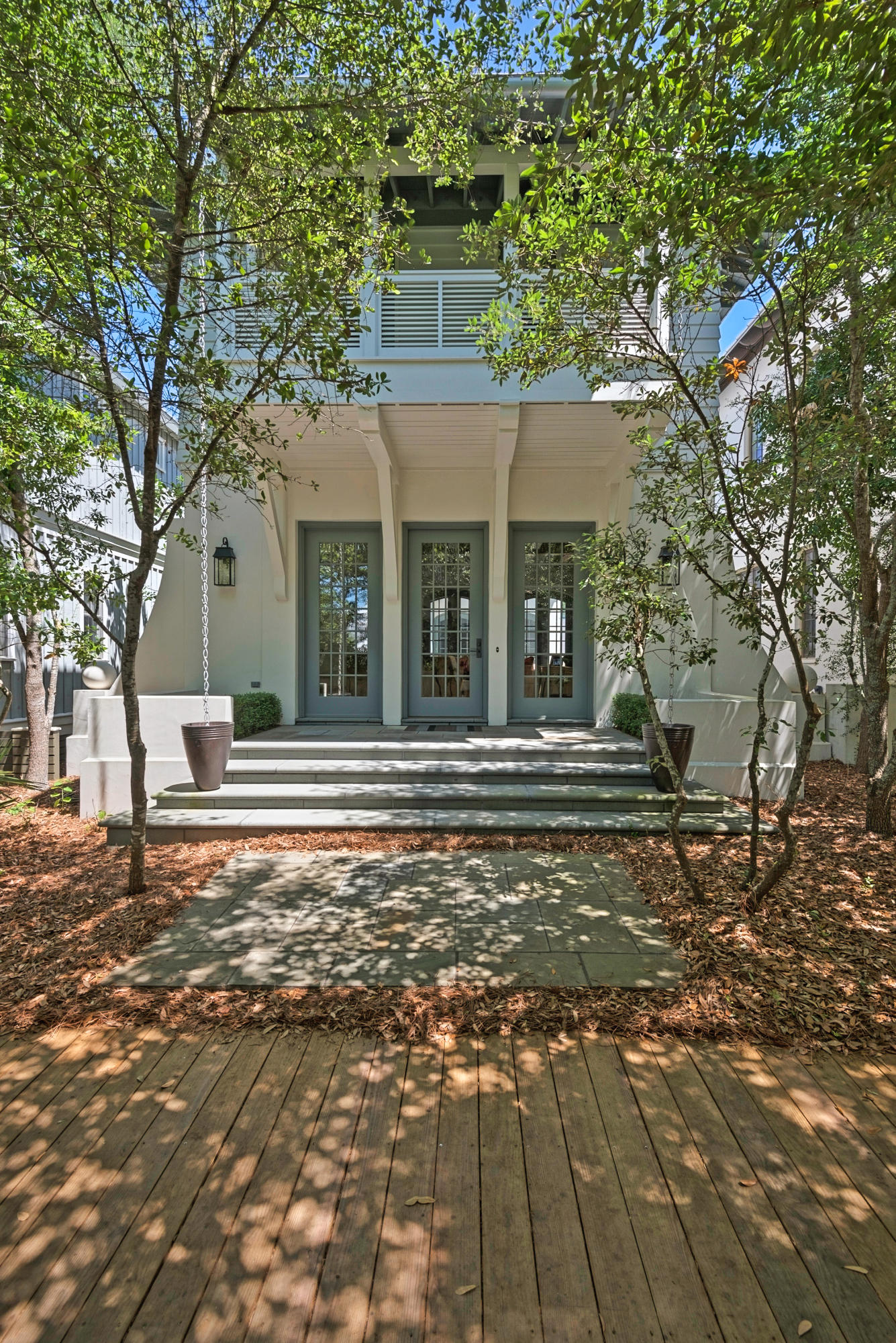 This stunning Florida home presents an unusual and appealing blend of sleek and modern and Old World with touches of New England. It's a place where privacy is treasured and impeccable craftsmanship is revered. One outdoor courtyard on gray cobblestone features a covered grilling and prep space along with a cushioned built-in bench and patio dining table for 6 or more or less and mingling of many. Another large, private patio space features comfy chairs and a water feature on a slate floor. The second floor hosts the master suite with private porch, a library wing flooded with natural light, an office, laundry and 2 additional guest rooms with en suite baths.