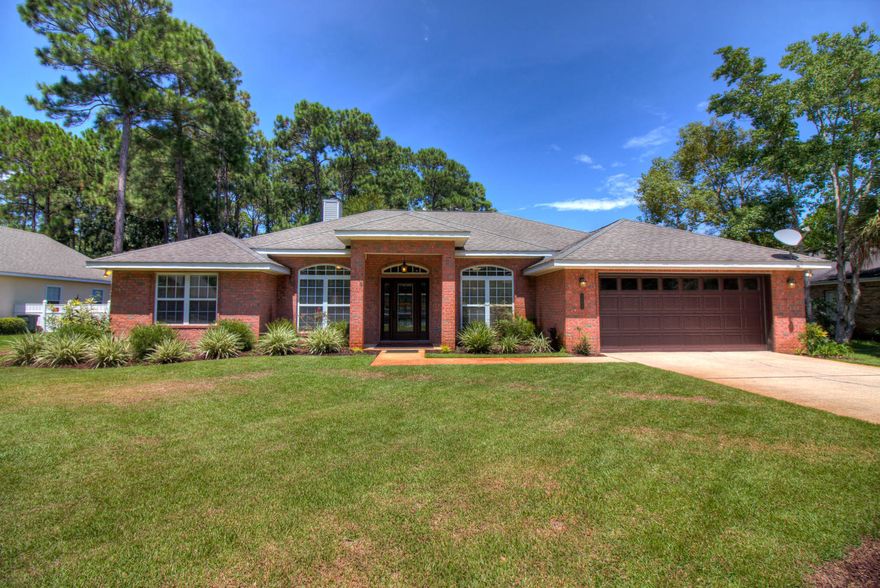 Welcome to your tropical pool paradise! You will fall in love with this gorgeous all-brick classic executive home with relaxing private garden oasis. Wonderful floor plan featuring custom built-ins, tile, hardwood flooring, with carpet in 2 bedrooms. Formal dining room plus French doors open to front office or parlor. Kitchen has breakfast nook, granite countertops, tile backsplash, stainless steel appliances, double oven, farmhouse sink, eat-in bar, and great storage with view to living room and pool. Master suite has large bathroom and walk-in closet. Enclosed lanai with heated, saltwater pool and hot tub plus gas grill hook-up. Low maintenance fenced backyard with meandering garden pathway around pool. Total yard irrigation system, 2 car garage, new AC unit in 2016. Located 1 block from the Bay (with 2 Bayside parks), just 1/2 mile from the beaches of the Gulf of Mexico, and central to Destin Commons, Silver Sands Outlets, and Sacred Heart Hospital. A tuly Must-See Home!