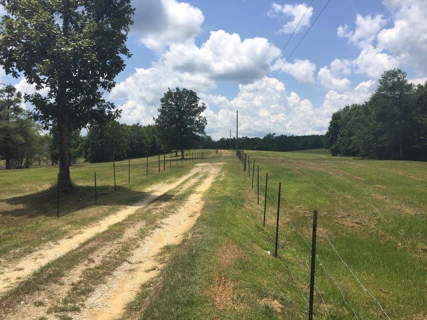 Beautiful rolling hills property with 49 acres, 40 x 40 barn, and a double wide mobile home with fencing on 3 sides. Approx 40 acres are pasture, including a wet weather pond and Hughes Ditch run through the property. Home has concrete block skirting with an attached 2 car garage. Barn has 3 single and 1 double stall with concrete floor. Office in barn is heated/cooled. Well is approx. 6 years old. Survey available. Equipment is negotiable. Buyer to verify all dimensions.