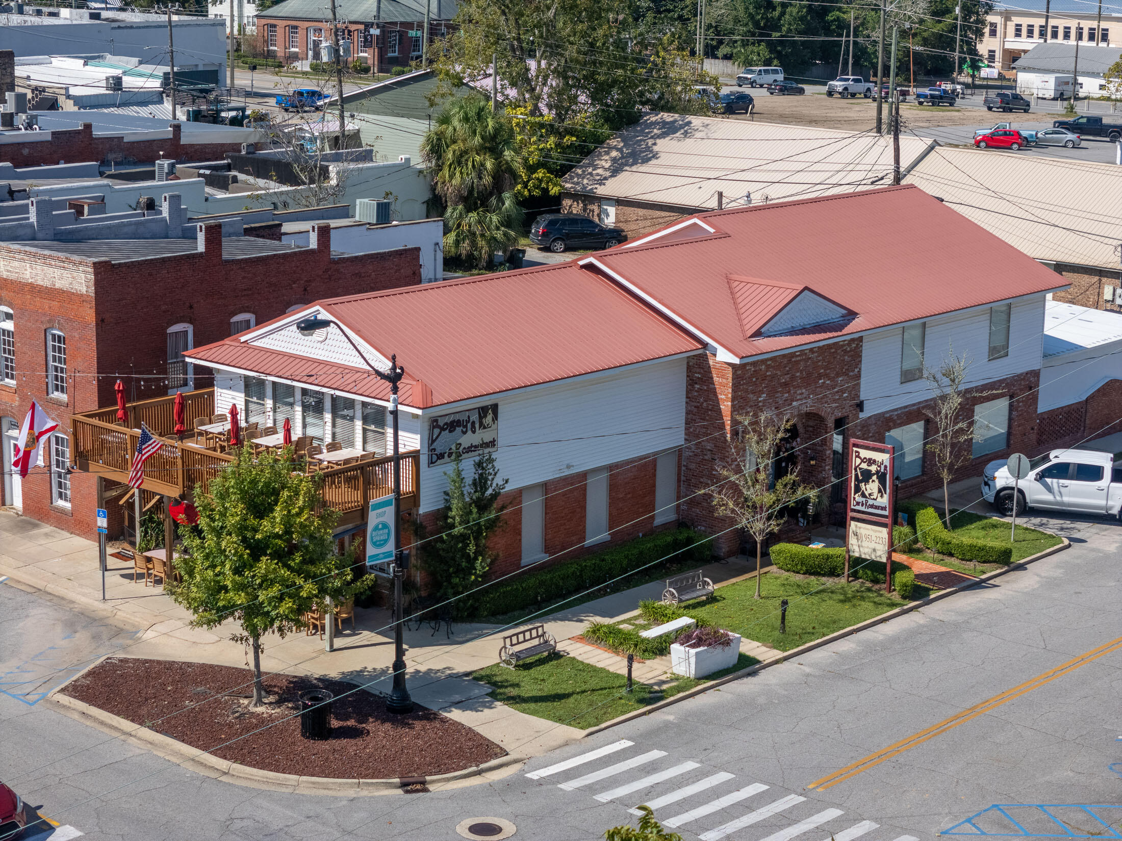 Own a piece of DeFuniak Springs history! Located on charming Baldwin Avenue, Bogey's Restaurant has long been a local favorite, and now this prime downtown property is available for purchase. Whether you're a real estate investor, restaurateur, or entrepreneur, this unique opportunity offers multiple options to make it your own. NOTE: Bogey's will proudly continue serving the community and its loyal patrons through the end of 2024. Located in the vibrant downtown district of DeFuniak Springs, the two-story building enjoys high foot traffic, ample parking and easy accessibility, making it a prime spot for any commercial venture.  Option 1 - Real Estate Only: Acquire the real estate and benefit from this prime location in the heart of downtown. With 6,367 total SF and 5,493 SF heated and cooled space, the property boasts high visibility on the corner of Baldwin & 6th Street with parking all around. This rare downtown standalone building underwent a complete renovation in 2015, including all new plumbing, electrical, fire sprinkler system, handicap lift/elevator, newer HVAC units and a new metal roof in 2017. The property's character and charm are complemented by its recent upgrades and compliance with building codes, including ADA. 

Let's get creative, shall we? Additional income opportunities abound should you choose to utilize the downstairs for your business and lease out the upstairs; transform the upper floor into multiple offices, one large rental space, or even convert a portion into one or two residences. The possibilities are only limited by your imagination! This type of creativity can create lasting passive income to offset a mortgage. 

Option 2: Real Estate + FF&E (Fixtures, Furniture and Equipment)
Looking to launch your own restaurant concept? This option includes all the fixtures, furniture, and equipment necessary to operate, providing a turnkey solution for a restaurateur ready to hit the ground running. With a fully equipped kitchen and multiple bars and dining areas, this is an excellent opportunity to start fresh while saving the cost of setup.

Option 3: The Whole Enchilada! 
Step into a thriving, well-established business! This option includes everything: the real estate, FF&E, Bogey's name, recipes, and the considerable customer database and social media accounts. Continue the legacy or make it your own with a few personal touches. With its strong following and reputation for quality, this is a rare chance to take over a successful restaurant brand in a growing community. The business is already primed for success, with every detail ready for seamless continuity.

Property Features & Layout

Downstairs Features:

~ Fully equipped kitchen
~ Dining room with seating for 150 guests
~ Full bar for drink service
~ ADA-compliant bathroom
~ Staff bathroom
~ Handicap lift/elevator for accessibility to second floor 

Upstairs Features:

~ A second bar and dining room with seating for 35+ guests
~ A large meeting room that accommodates 50+ guests, ideal for events, banquets, or conferences
~ 2 ADA-compliant bathrooms
~ The piece de r??sistance: an upper-level dining deck that offers stunning views of Lake DeFuniak, a serene backdrop for unforgettable dining experiences.

Don't miss this unique chance to own a piece of DeFuniak Springs downtown charm. Please respect the staff and owners by not contacting them directly with questions or showing requests. Contact your favorite agent today for more details about the different purchase options and to schedule a private tour!