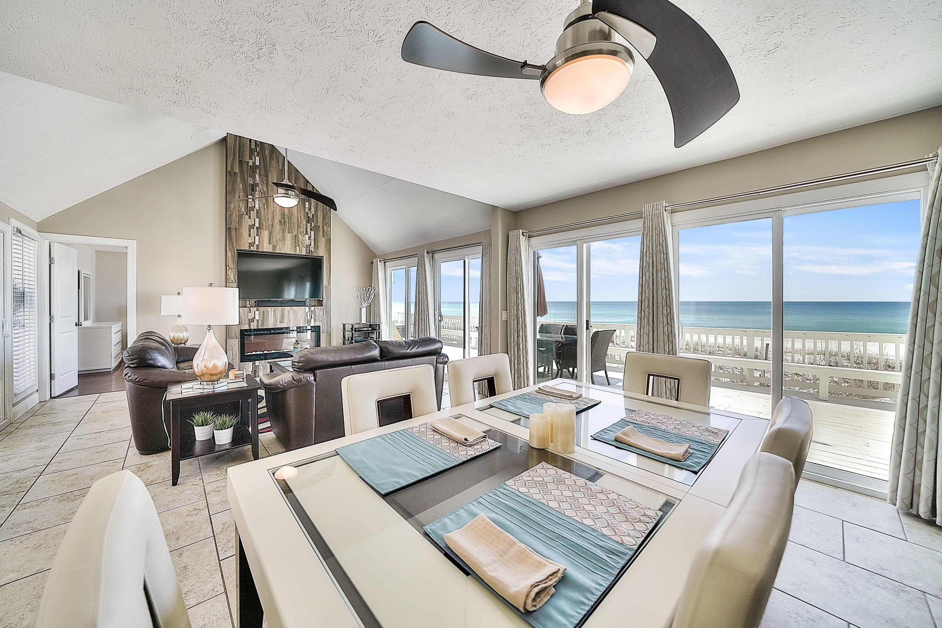 Lowest priced gulf front home in Panama City Beach!!! PRICE REDUCED!!! MAKE AN OFFER!!! GORGEOUS .... RENOVATED ... GULF FRONT HOME !!! You must see this beauty. The kitchen features thick granite, stainless steel appliances, modern pendant lighting, espresso cabinetry with brushed satin nickel hardware and an island for the glass cooktop with overhead exhaust- it's a Gourmet Chefs Kitchen for the cooking enthusiast! The living room is spectacular with a custom floor to ceiling tiled electric fireplace and large flat screen TV. Relax by the ambience of the fire while enjoying the sweeping gulf views. The master bedroom is gulf front with sliding door access to the oversized deck leading out to the sugar white sandy beach. The fireplace can be enjoyed from the master bedroom. There are 2 additional bedrooms and 3 full baths along with an attached garage. This gulf front home is all one level and ready to be enjoyed. It is move in ready and/or rental ready. Come view this beautiful home today!