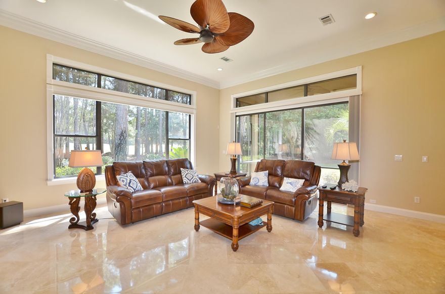 This one level elite home located in the exclusive gated community of Burnt Pine is an entertainer's dream. The open concept with wet bar, formal dining room and wine refrigerator provides an excellent opportunity for hosting friends and family. The chef's kitchen featuring granite countertops, stainless appliances and custom tile backsplash will make cooking a pleasure. Soak in the natural sunlight through floor to ceiling windows in the comfortable living room with gas fireplace. Lounge on your spacious screened patio with views of Burnt Pine's #7. A barreled ceiling leads to the master suite offering his and her closets, dual vanities, luxurious soaking tub and separate shower. An executive office, travertine floors and ample storage makes this the ideal property for