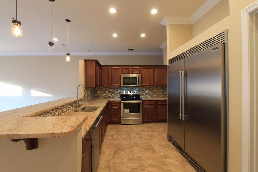 Awesome new floor plan by past parade of Homes, multiple award winner! This 4/2 custom brick home has super curb appeal. There are be 10 ft. ceilings w/ impressive crown molding, tile flooring, and 5 1/4'' baseboard throughout the main living areas. As you approach the front of the home, you will be quite impressed. The covered porch is very welcoming, and the gorgeous leaded glass door, makes for a grand entrance. The formal dining room is at the left of the home's front and has an attractive arched entryway that leads to the kitchen. The chef's delight kitchen l boasts custom maple cabinetry, granite countertops, a wet bar with beverage cooler, a large pantry, and stainless appliances,  (including an oversized commercial grade frig./freezer). At the right of the home's entrance is bedroom one, continuing down the hallway is the guest bath, then bedrooms two and three. The oversized greatroom is located at  the rear of the home and opens to a covered porch, which is perfect for entertaining. The master suite is large, has 2 large walk - in closets, a linen closet, a walk - in shower, a whirlpool garden tub, and a double vanity. The laundry room is at the rear of the kitchen, and has a door which opens to the garage. The yard will be beautifully landscaped and comes complete w/ a well, sprinkler system and timer. Insurance will be very reasonable, as home is built to today's code and window coverings are being provided for storm protection. Home has a Taexx ''in the wall'' pest control ll be beautifully landscaped and comes complete w/ a well, sprinkler system and timer. Completion expected on late Oct. '16.