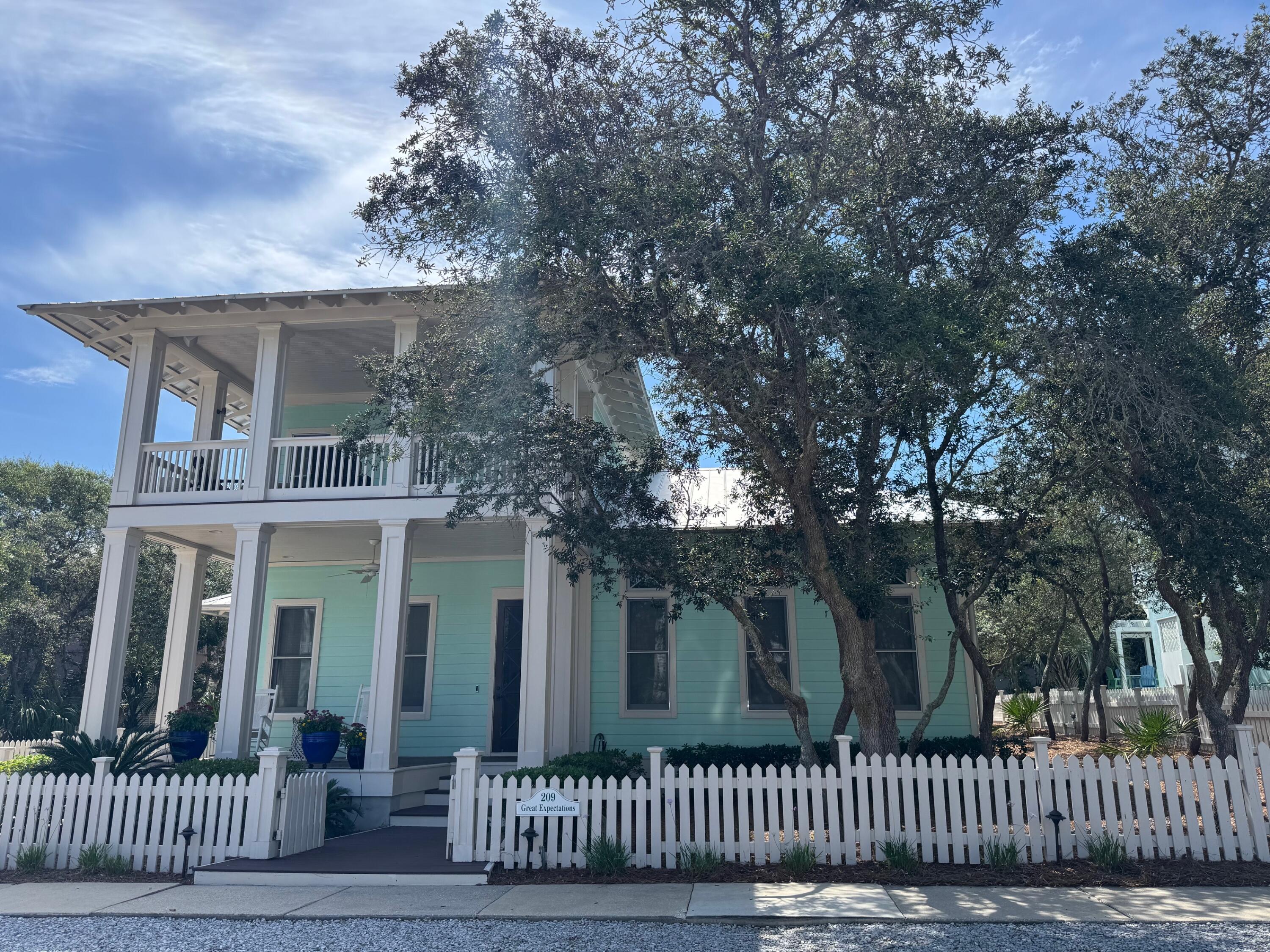 This southern cottage-style beach house, masterfully designed by renowned AIA architect Gary Justiss, is nestled in the serene, private gated community of Carillon Beach. Offering a blend of exclusive privacy and contemporary elegance, this home offers an unmatched living experience near the sea.The house boasts three nicely appointed bedrooms and four baths, providing ample space for family and guests alike. The master suite, conveniently located on the first floor, features elegant design and comfort, making it a perfect retreat after a day spent by the ocean. The living spaces are graced with tall ceilings that enhance the airy and open feel.Living spaces extend seamlessly outdoors to the spacious porches, offering a view of the surrounding landscapes and the perfect setting for relaxation or entertaining. The outdoor area further enhances the leisurely beach lifestyle with a convenient outdoor shower, ideal for rinsing off after a beach day, and a bike shed to store beach gear.
Adding to the function and charm of the property, an outbuilding is currently utilized as a combination mancave and greenhouse. This additional structure offers potential for various uses, adapting to the homeowner's lifestyle needs.
The ample backyard, set against a backdrop of lush greenery and coastal breezes, features raised bed planters for gardening enthusiasts. This space is also suitable for accommodating a pool, offering potential for an idyllic outdoor oasis tailored to leisure and entertainment.
Each detail in this home speaks of thoughtful design and high-quality craftsmanship. This beach house embodies a lifestyle perfect for those seeking a permanent residence, a holiday home by the sea, or an investment property.