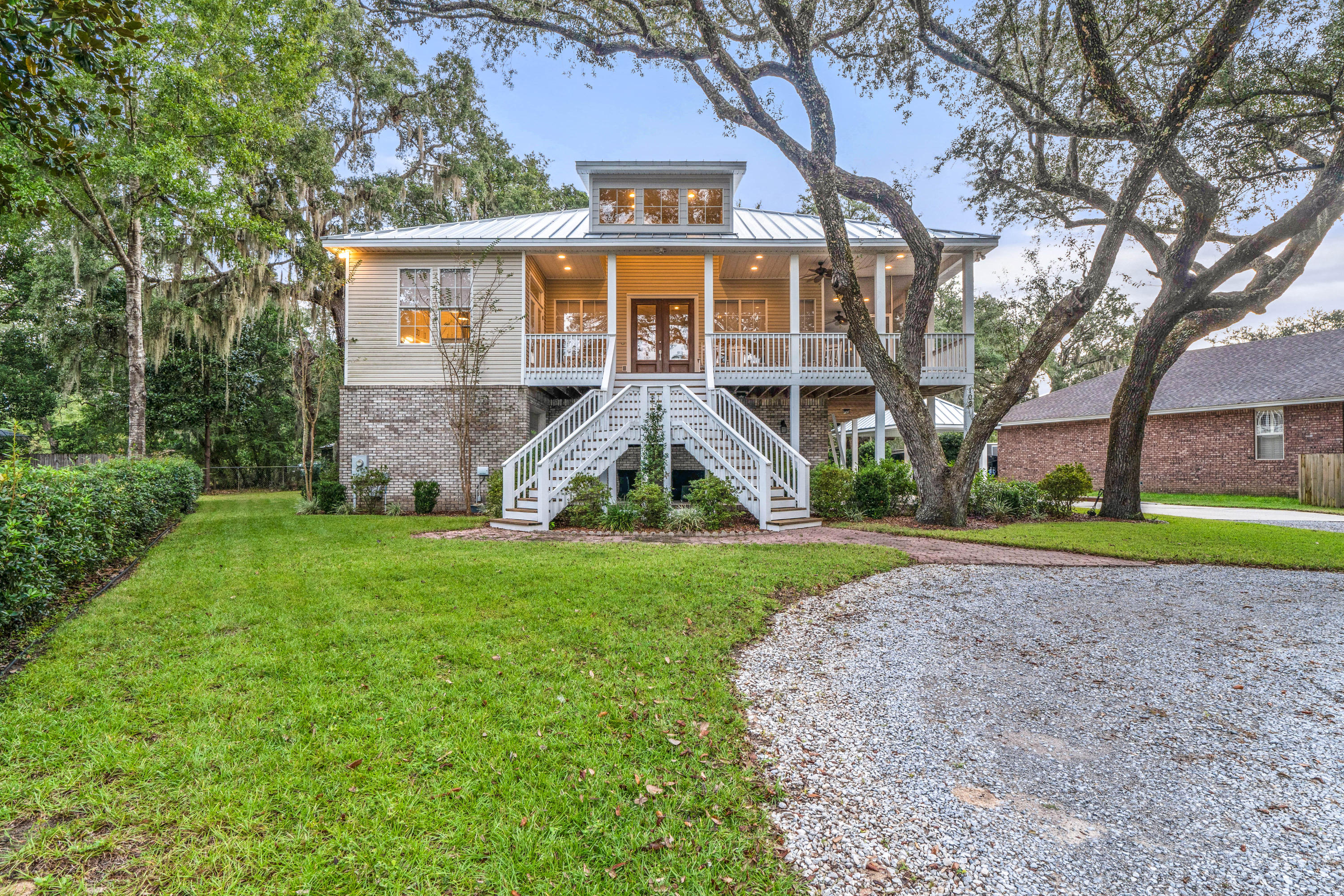 This is your opportunity to own a true piece of the South with a water view! This custom built Southern Living floorplan is builder owned and there is no skimping on the upgrades. There is a 1400 sqft. covered, wrap around porch with a large portion screened in. There is over 900 sqft. of garage space and also a 3rd garage door to a golf cart room that is currently set up as a home gym. The roof is standing seam commercial grade galvalume metal and there is a matching 240 sqft. covered carport that offers extra parking and protection from the elements. The yard is lush and beautiful with many mature live oak trees and is fully landscaped. The property is conveniently located and within walking distance to Lions Park, a public boat ramp, Niceville Yacht Club and many premier restaurants.