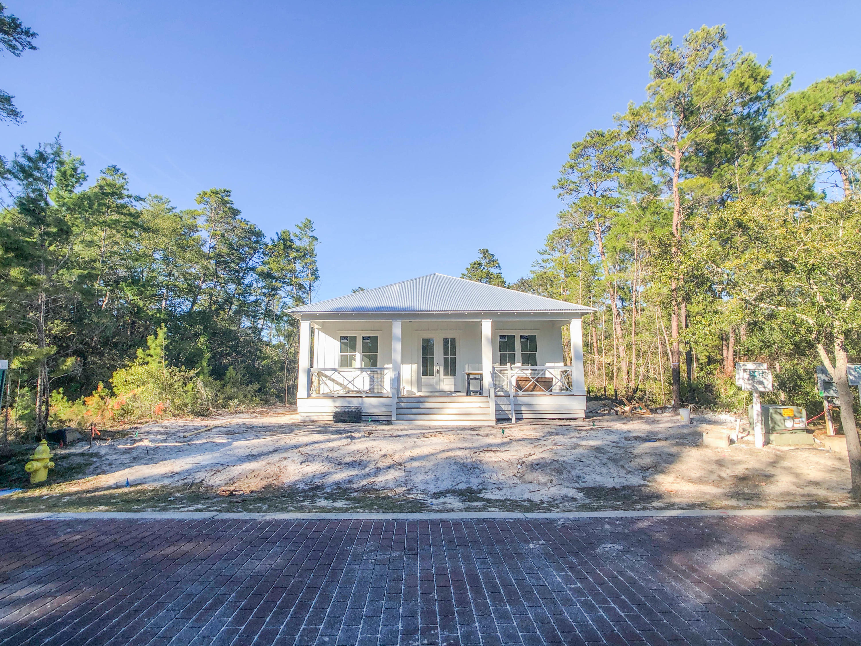 Located in peaceful Grayton Bayou on an interior lot, just a block from the Choctawhatchee bay this gorgeous, 3 bedroom, 2.5 bathroom, new construction home is near completion. This thoughtful design has many notable features including 10'' ceilings, two covered porches, shiplap, shaker style cabinets, walk-in pantry, giant kitchen island with quartz countertops, stainless appliances, tile flooring in the baths and luxury vinyl throughout. The master suite has a humongous tile walk-in master shower with plenty of relaxing room plus bench seat. The exterior of the home features a detached one-car garage, sprinkler system and gravel driveway. The community amenities include pool, neighborhood boat launch, brand new county built public bay park with dock and picnic area. Owners can enjoy ever