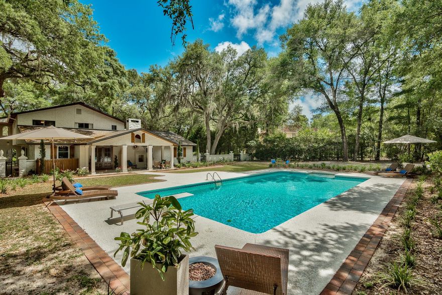 1.1 Acre PRIVATE Estate on prestigious Edgewater Drive. This home has been redesigned and renovated with no detail overlooked. Moss laden oak branches canopy the circular driveway. Iron gates open to a magical backyard. Large pool, stunning trees & unmatched privacy. Multiple outdoor areas create an intimate feel. The covered porch with outdoor fireplace is a perfect place to entertain. Wood and stone flooring throughout interior. Granite & marble in all baths. Monitor and control this home's security cameras, lights, garage doors & entry door locks from your iphone. 4 beds 4 baths, 2 living areas & dining. Dream kitchen with 36''KitchenAid Stainless range, granite counters & large island. High celings and large windows. New AC, New roof. Just painted, like new.