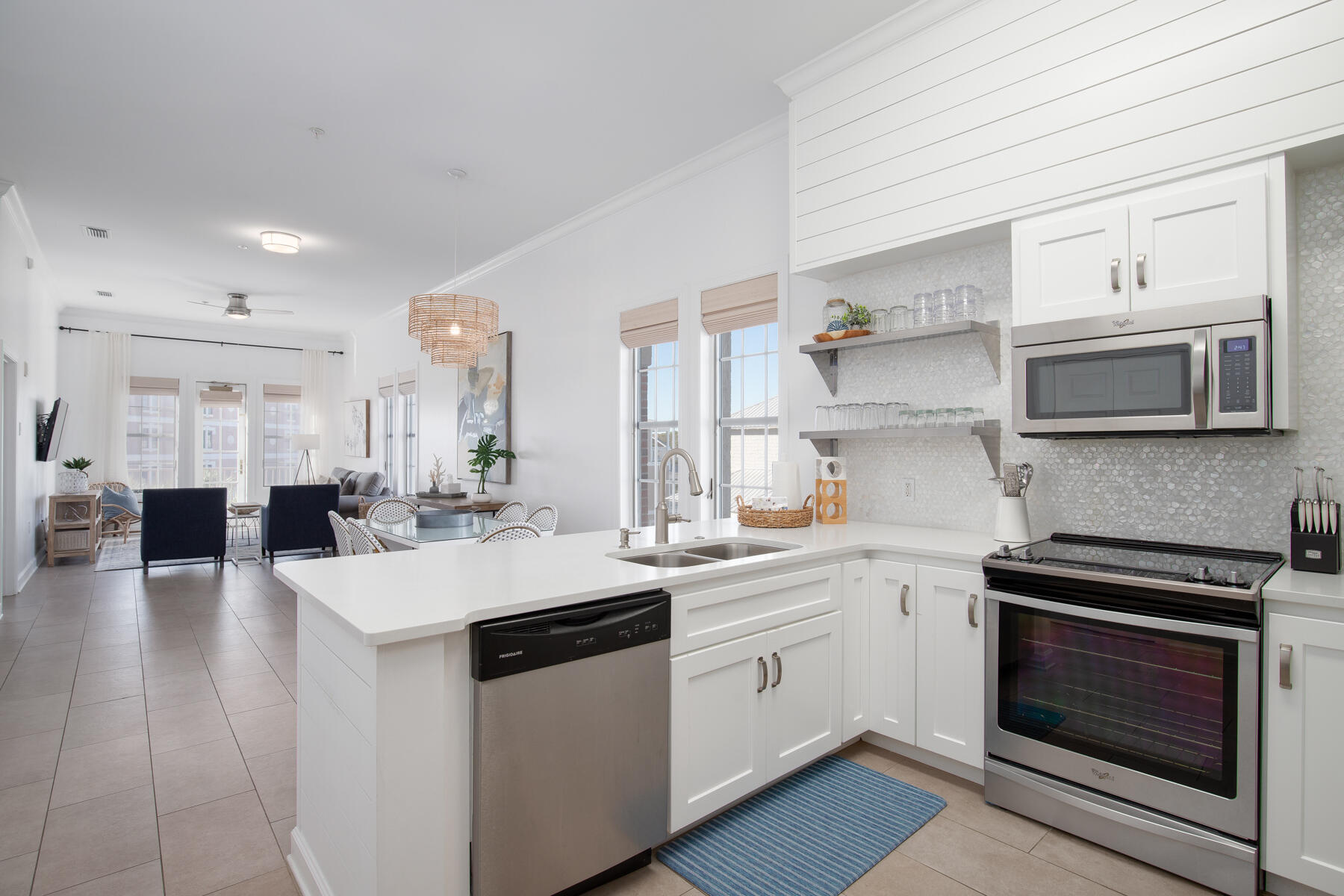Live in luxury and enjoy all the best the 30A lifestyle has to offer with this 3BR/2BA stunning condo located in the heart of Inlet Beach. All within walking distance to the beautiful beaches, world class dining and shopping of Alys and Rosemary, but still tucked off the main highway enough to enjoy the peace and seclusion of the private Villages IV complex. This spacious corner unit is situated on the top floor of the building and features large windows allowing lots of natural light into the home. Enjoy the sunset on the balcony, or indulge in one of the two resort style pools within the community. The large open floor plan is one of the largest in the complex, and really maximizes the spaces for ultimate comfortability and practical living.