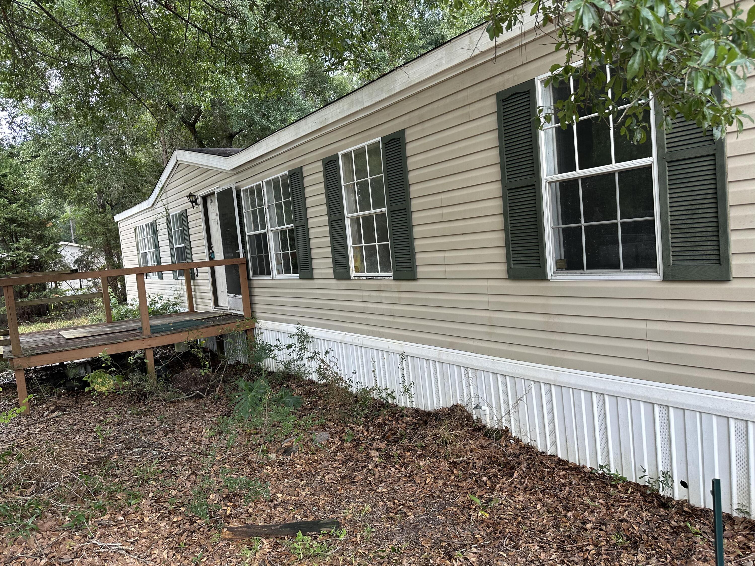Have you been looking for a fixer upper property with plenty of land? Here is your chance to pick up this 3/2 double-wide situated on 1 acre of property. With some love, time and sweat you can build TONS of equity into this property. 1 Full acre corner property with plenty of mature hardwood trees provide plenty of natural shade and privacy.