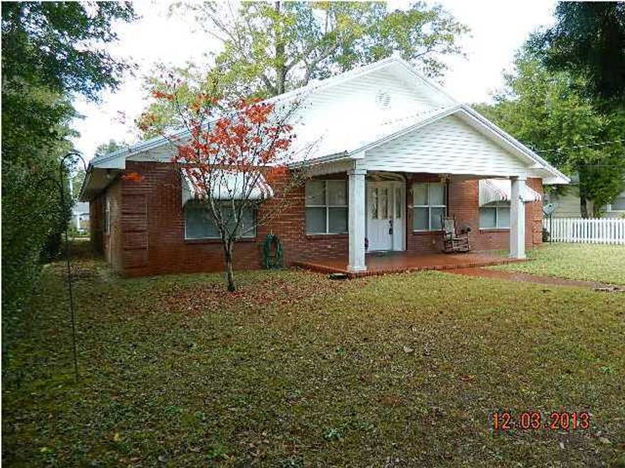 Lovely downtown DeFuniak Springs red brick home just 2-3 blocks to Lake DeFuniak. Galvalume metal roof is 2 yrs. old. Ceiling fans in every room except bathrooms. Large utility/laundry room off garage entrance. Kitchen has Jennaire stove, 2 ovens, microwave, instant hot/cold water dispenser, corian countertops, island, lots of organized storage, parquet wood flooring in kitchen/dining room. 3 Bedrooms, 2 baths with corian countertops. Master bath has small shower, Jacuzzi style tub and double corian vanity. Bedroom closets are cedar lined. Large walk-in cedar lined closet in master bedroom. Huge 48.5'x18' living/family room with wet bar area. Office/den room. Marble columns on front porch. Two 50-gal. hot water heaters with on/off switch. French doors to back paver patio.