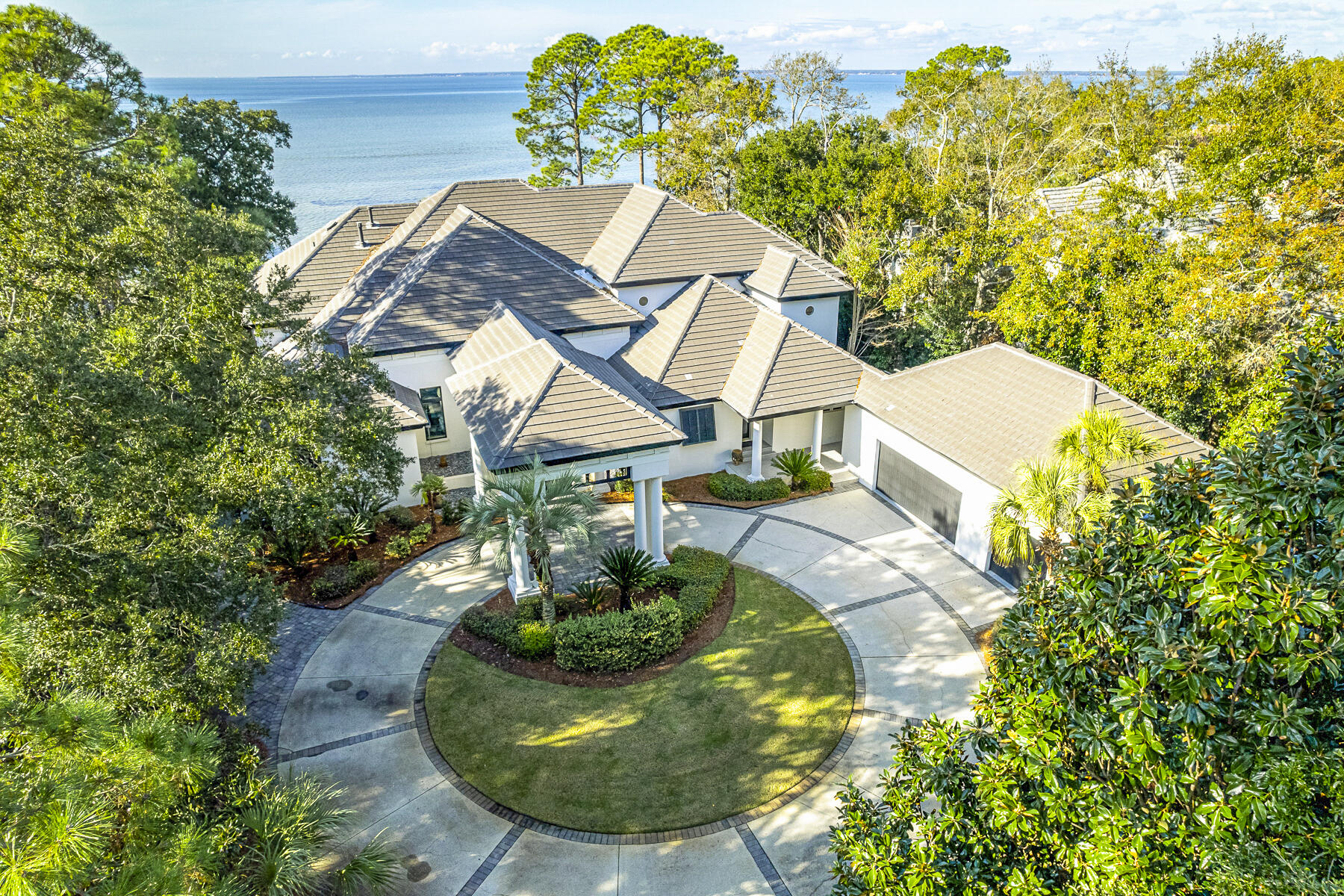 An extraordinary 1.5 acres and 104' of irreplaceable frontage on the Choctawhatchee Bay awaits you here in the private Burnt Pine neighborhood of Sandestin Golf and Beach Resort. With westerly sunset views, it's no wonder the original developer custom subdivided this exclusive Bayfront lot for his own use. The home features a winding drive with mature landscaping as you approach.  The current owner's passion for design transformed this home into a handcrafted masterpiece with Industrial Minimalist features. As you arrive through the elegant porte-cochere, the tall steel and glass entry doors open to huge cypress beams and columns holding lengthy cold rolled steel wrapped supports. Other steel features can be seen in the dropped kitchen ceiling with recessed lighting, the large...