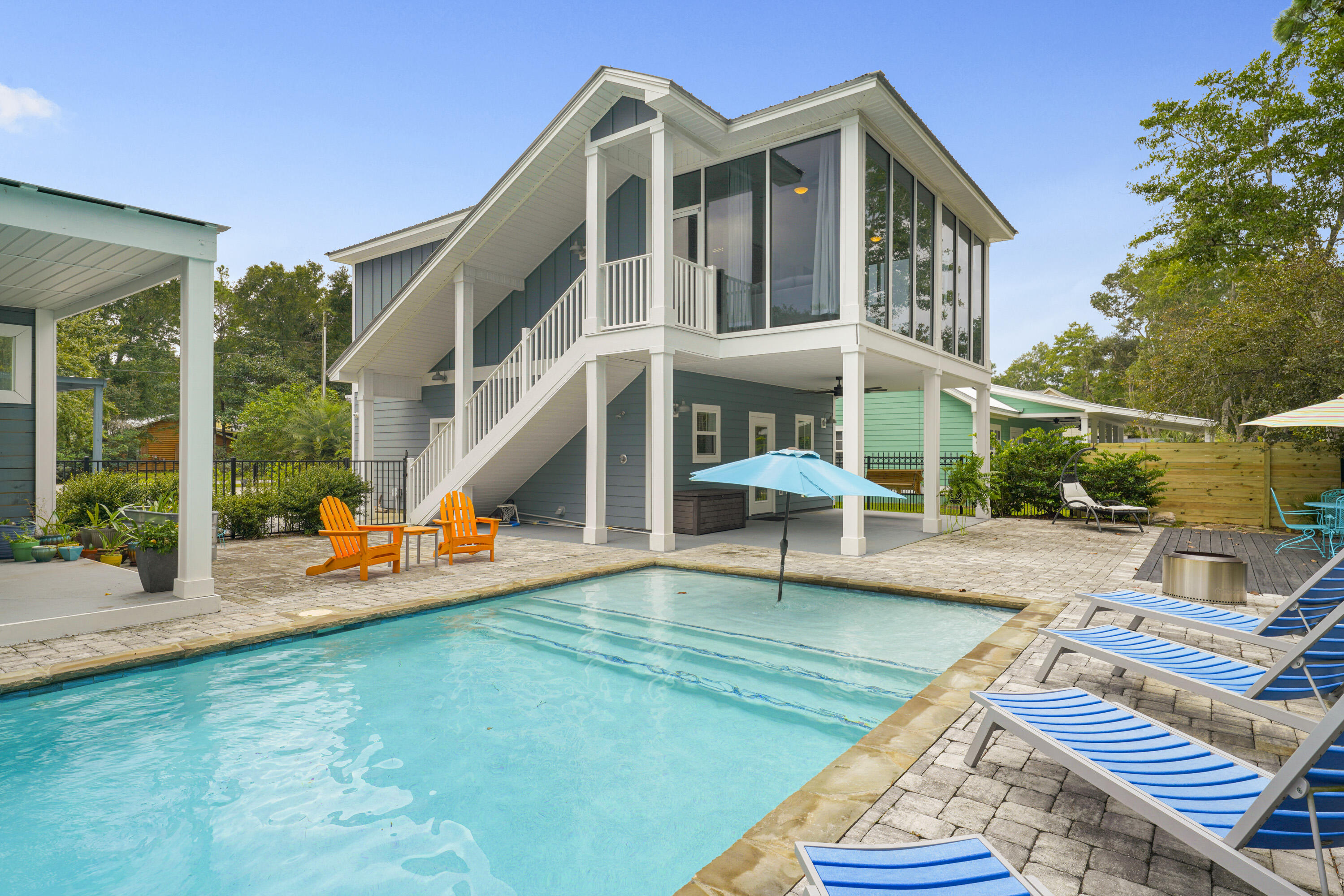 75 FEET of waterfront in the heart of Santa Rosa Beach! No HOA! Located in Point Washington, a charming community just a few miles from the pristine beaches of 30A, this property provides plenty of space to build your dream home, taking full advantage of the waterfront location and stunning views.  Featuring a private dock and covered boat lift, this is a boater's paradise, offering easy access to the bay and Gulf of Mexico. This property also features a private pool, a charming 2-story, 2-bedroom, 2-bathroom carriage house, and more! The carriage house provides a comfortable living space while you design and construct your dream home. The second level of the carriage house features a spacious four-seasons room, heated and cooled, with floor to ceiling windows on 3 sides, offering serene views of the surrounding landscape. It flows seamlessly into an additional living area, dining area and well appointed kitchen with a pantry. Beyond the living area is a large bedroom, walk-in closet and full bathroom. Downstairs features an additional bedroom and full bathroom, and the laundry room. 
Outside, the property also boasts a spacious multi-level decks, overlooking the canal, a private pool, and a luxurious summer kitchen, perfect for outdoor dining and entertaining. There's even room enough to build your very own pickle ball court!  Whether you're hosting guests or enjoying a quiet evening by the pool, this outdoor space offers everything you need. A 2-car garage, expansive driveway, and additional carport provide ample parking and storage. This property offers a unique blend of privacy and proximity to all that Santa Rosa Beach has to offer.  Don't miss out on this exceptional opportunity to live on the water while you create your perfect custom home! 