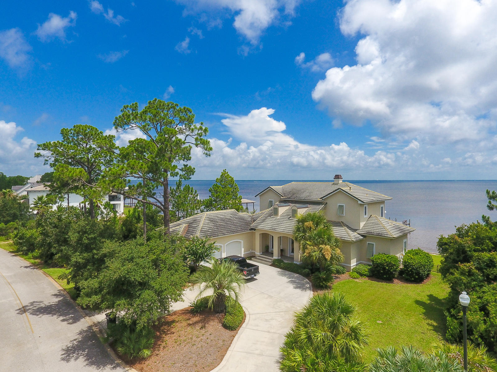 Custom built Bay front home in the quiet, gated community of Driftwood Estates! No detail was over looked in the design of this home. Large windows in every room boast the beautiful view of the Bay. The kitchen has custom solid pecan cabinetry, stainless GE monogram appliances, Thermidor gas cooking top, and 190 degree hot water dispenser. The master suite is on the first floor and has access to the lanai. The master bathroom has a temperature controlled shower feature, rain shower head, and a separate hot tub bath with new motor. Upstairs is a large rec room overlooking the water with built-in shelving. Two additional bedrooms upstairs each with a walk-in closet, bathroom and access to balcony. New sea wall caps and fill, a wired boat dock, outdoor shower and oversized 2 car garage.